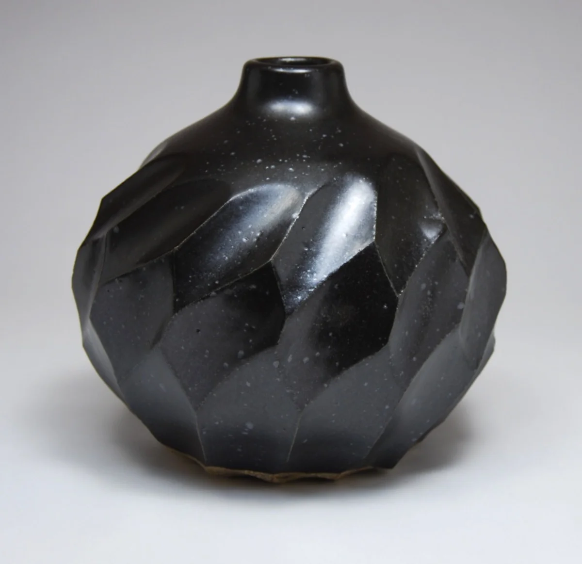 Round Black Faceted Bottle