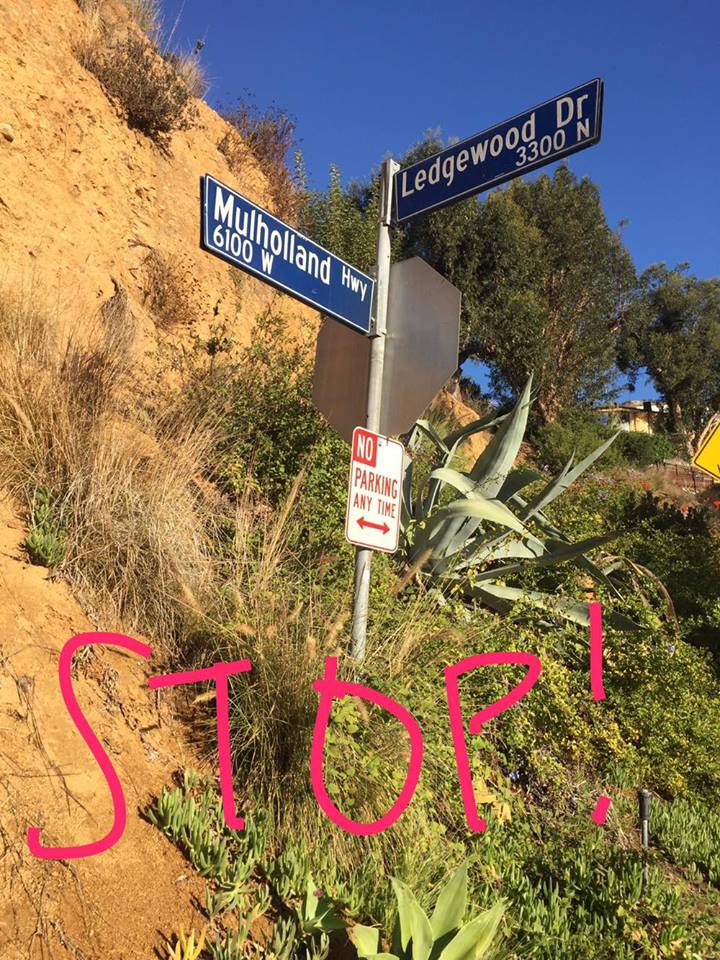 The ENTRANCE is right at MULHOLLAND HWY AND LEDGEWOOD DRIVE. Directly across from this sign you will see a house with the address 6150 MULHOLLAND HWY. 