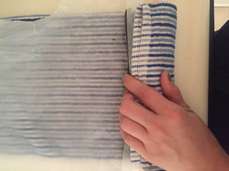 STEP 5: Grab underneath the towel again and roll everything over one last time making sure to tightly press down to make sure everything is held into place. 