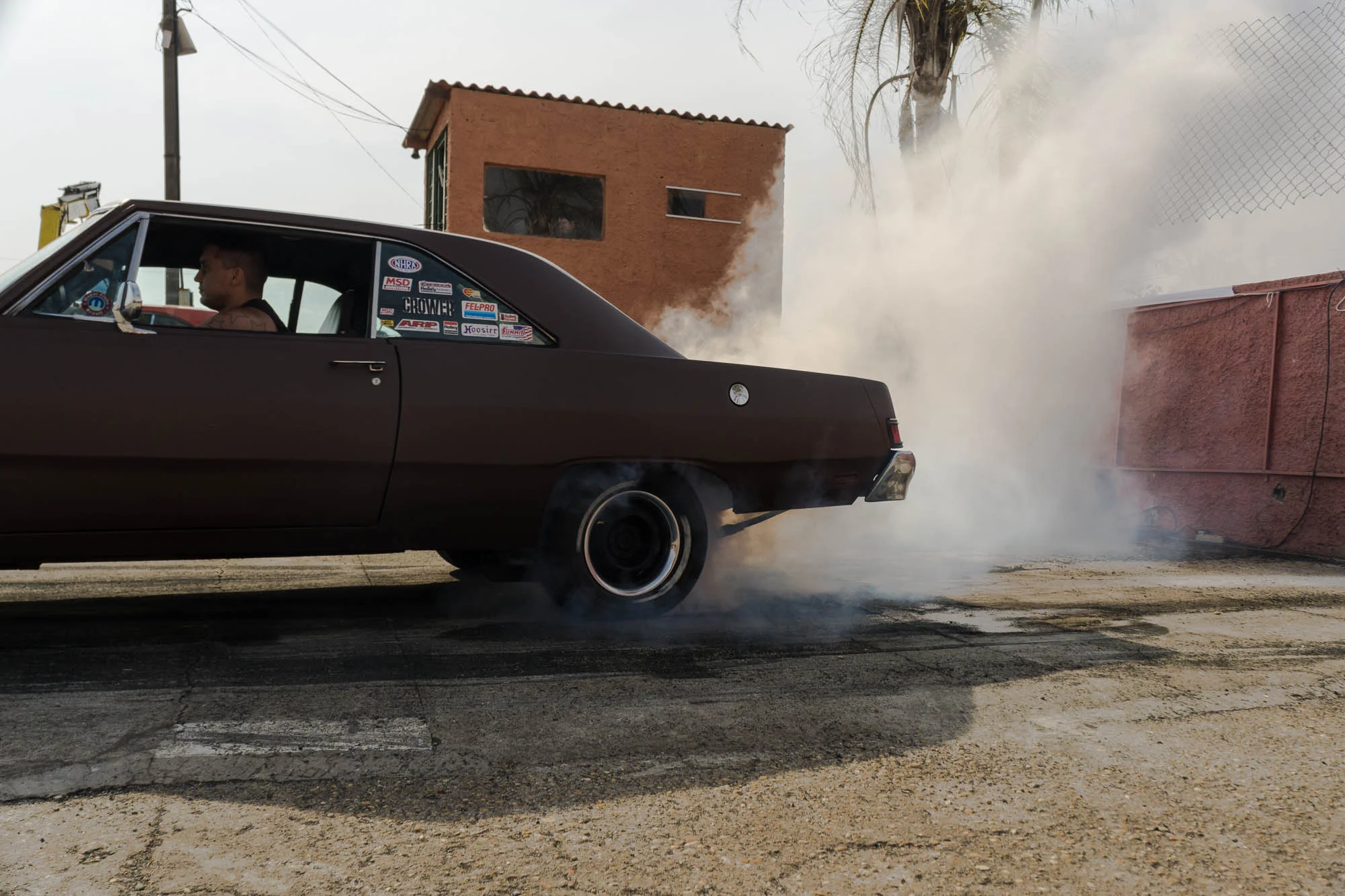 Brown Car Performing a Burnout