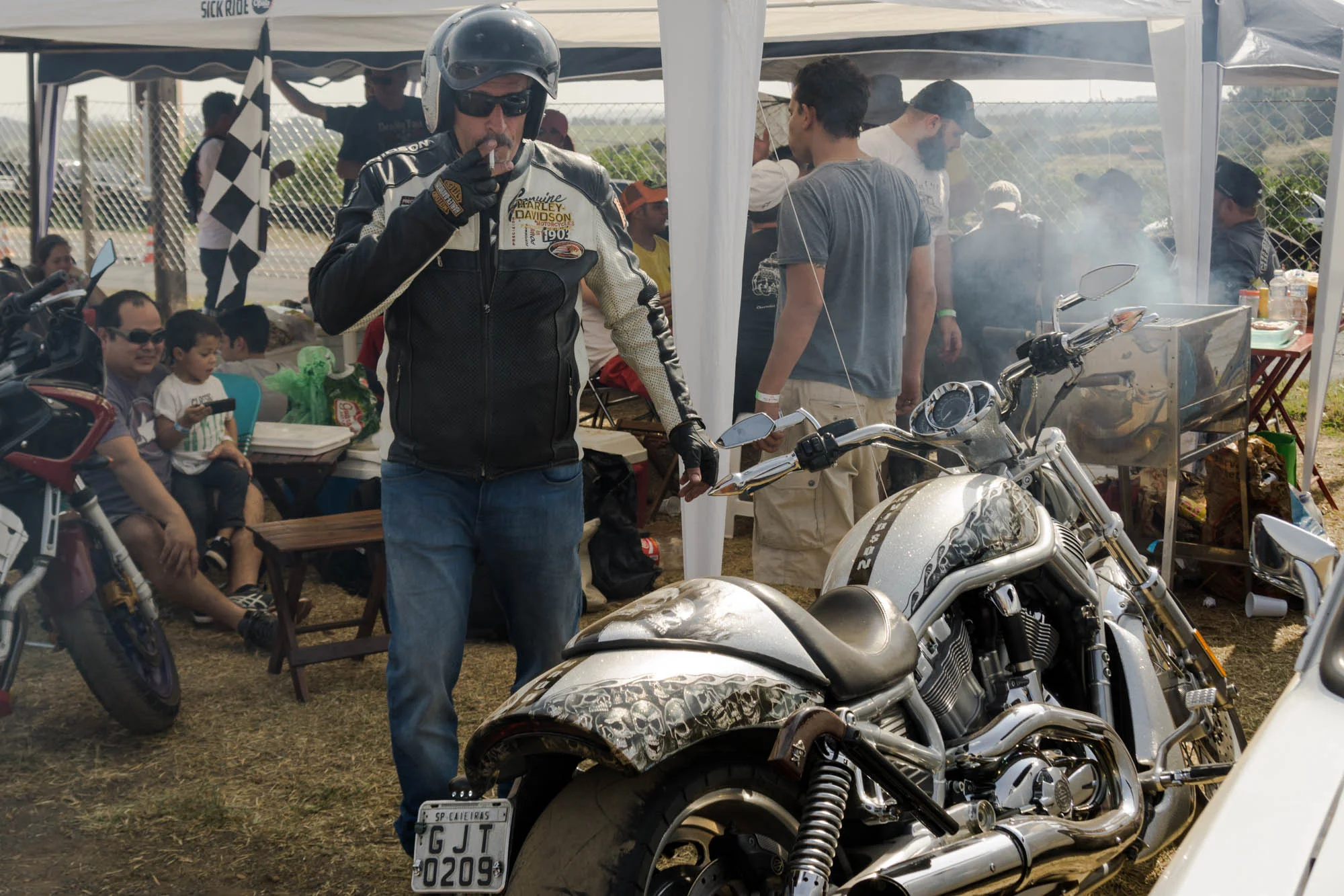 Man in leather jacket getting on a motorcycle