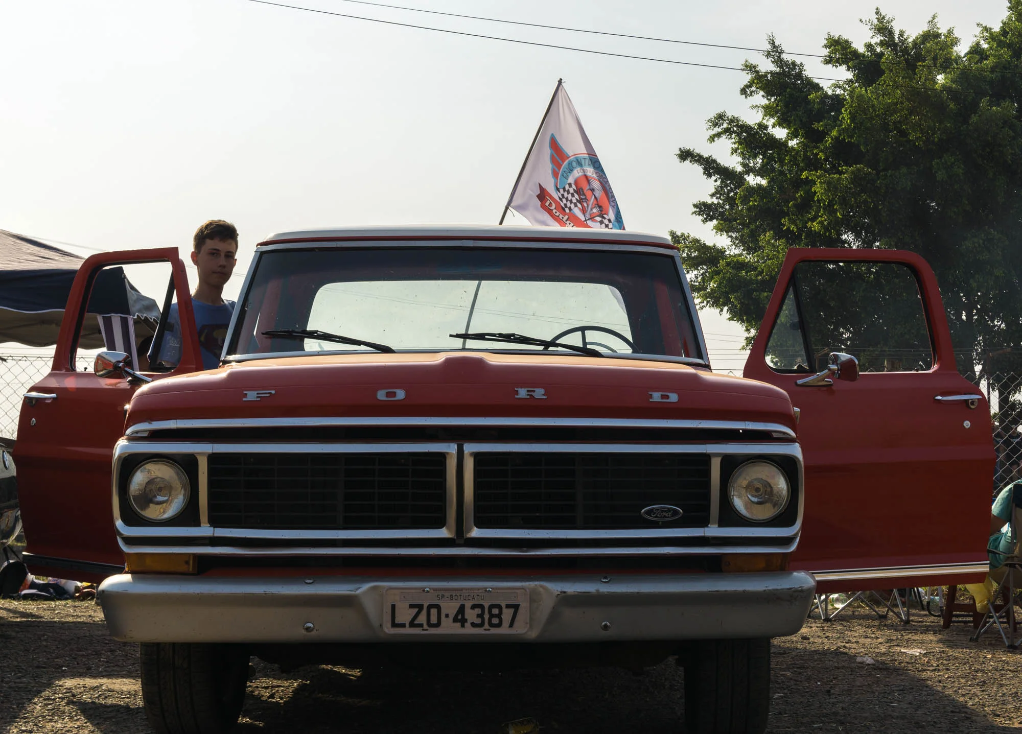 Boy Gets into Classic Red Ford Pickup Truck