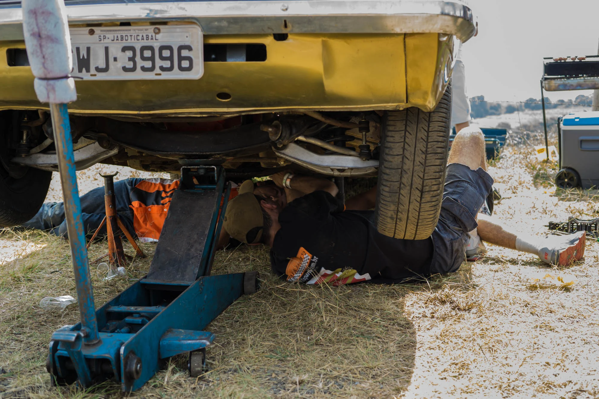 Two Boys working on a car