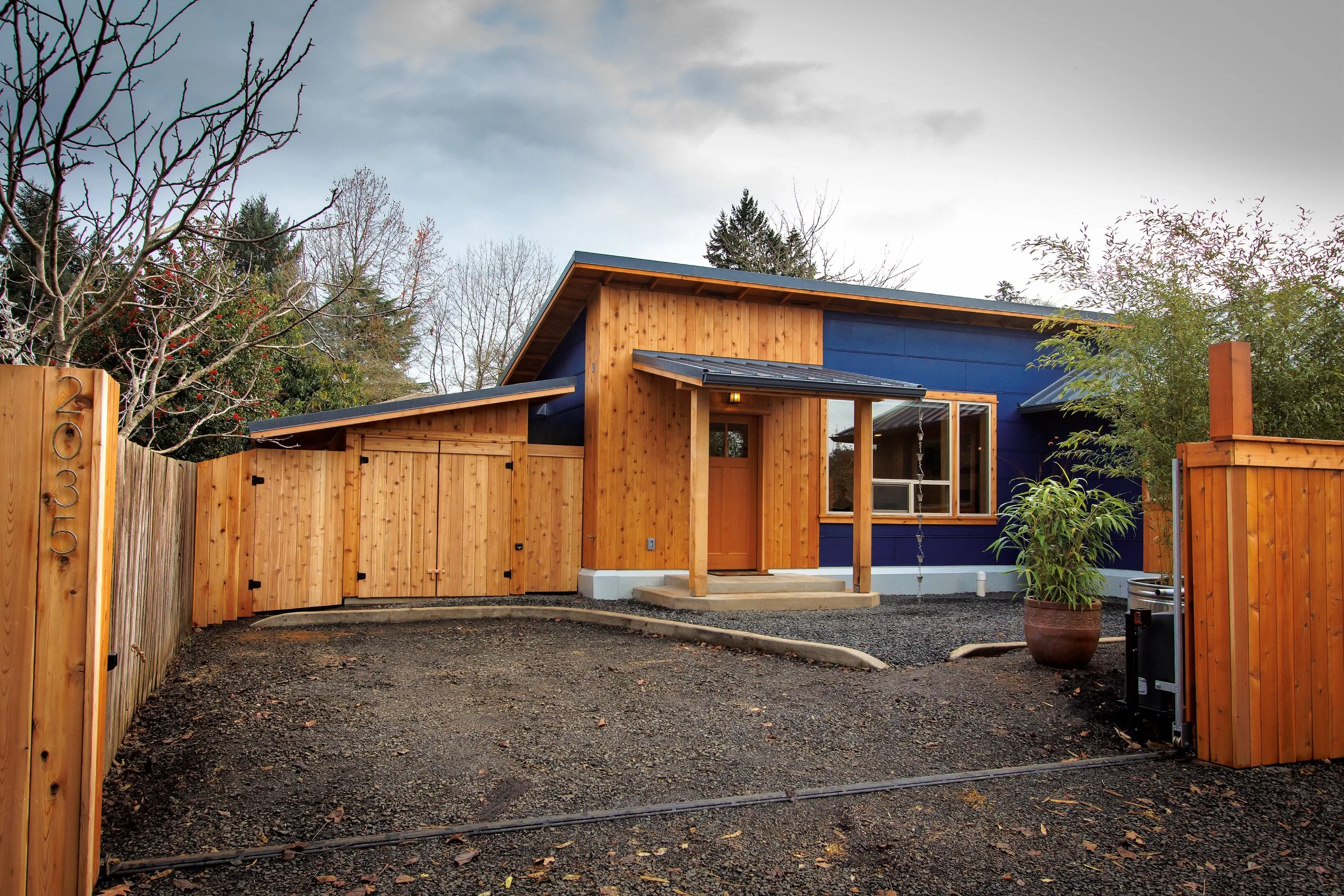 Exterior, showing onsite parking space and electronic access gate.