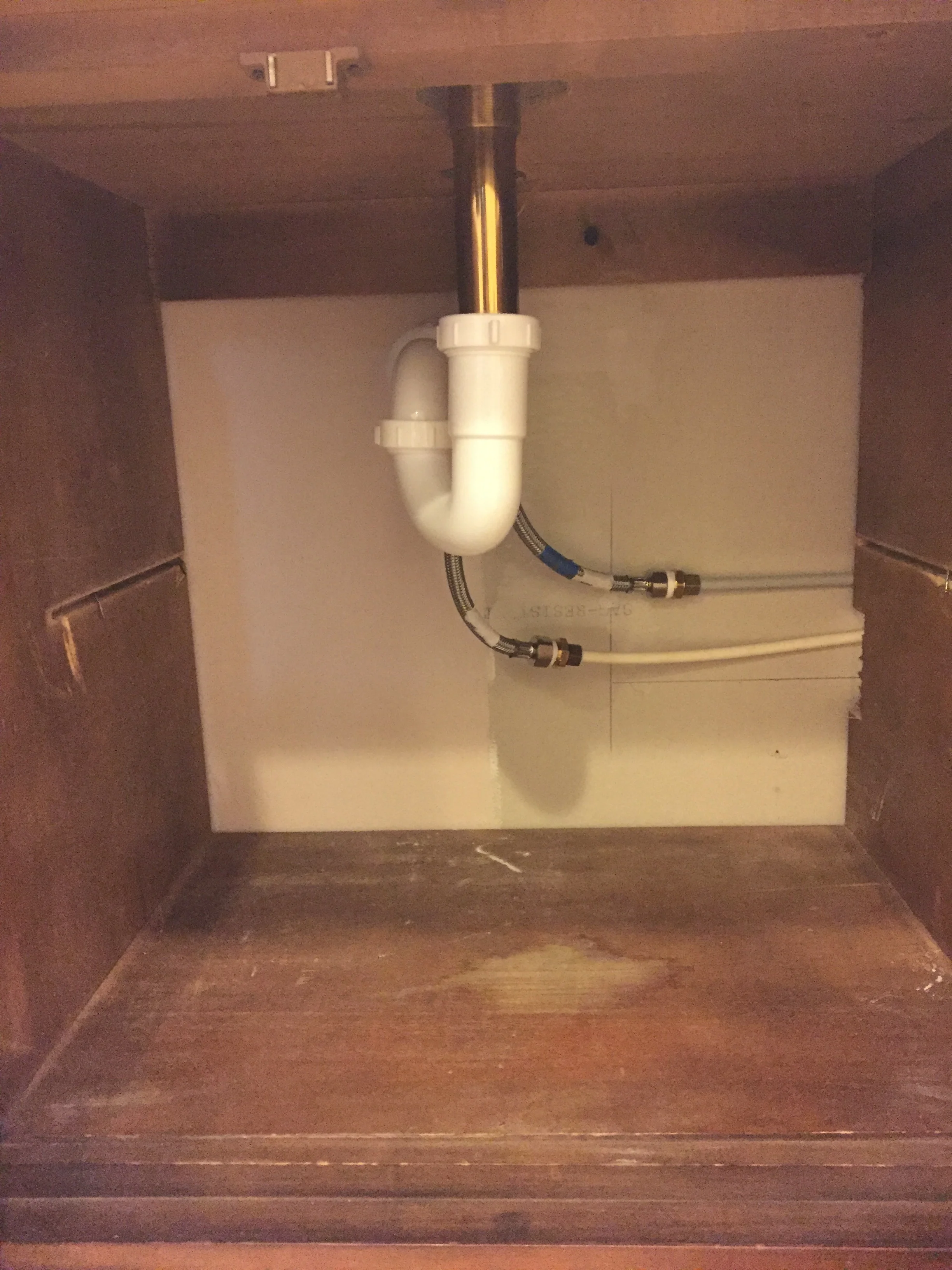 Unfortunately, the water shut off valves don't go into the wall on the same side as the drain, on the cabinet side. Noooo, that would be too easy......