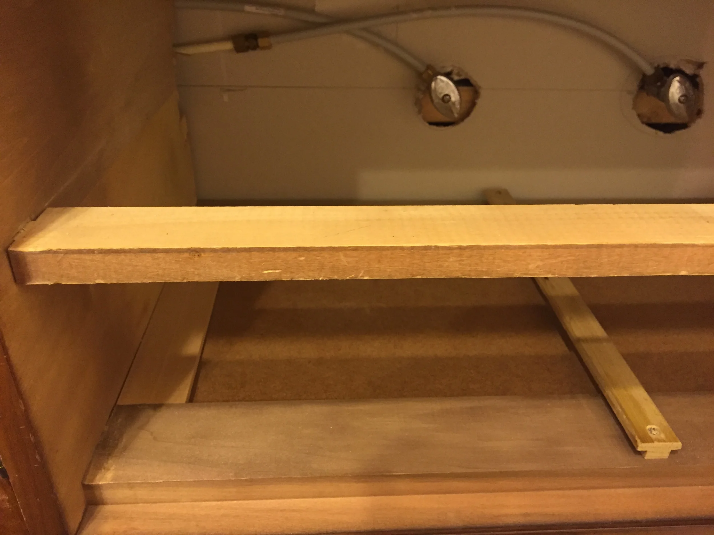 In order to make remove for the those water shut off valves, we had to completely remove the side and back drawer support rails for the middle drawer.&nbsp; See how there's only a front rail remaining?