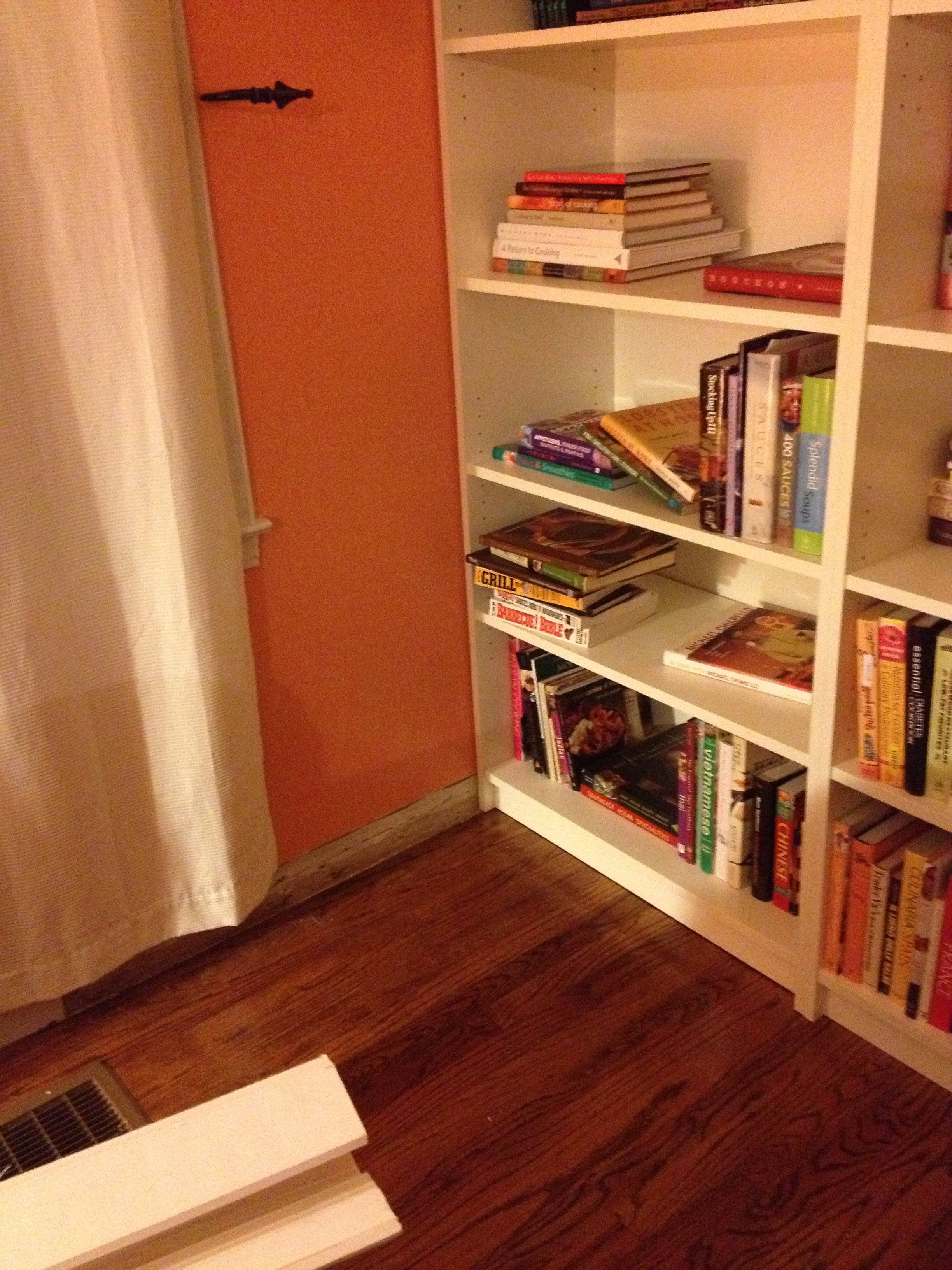 This is where the shelves meet the wall. Notice the cut out baseboard. Though these shelves fit in very snuggly, my husband was right about one thing. The plaster walls are not PERFECTLY straight. So, there are some places where the shelf and wall meet where there is space between them. Okay, so he was right about one thing.....ever.....
