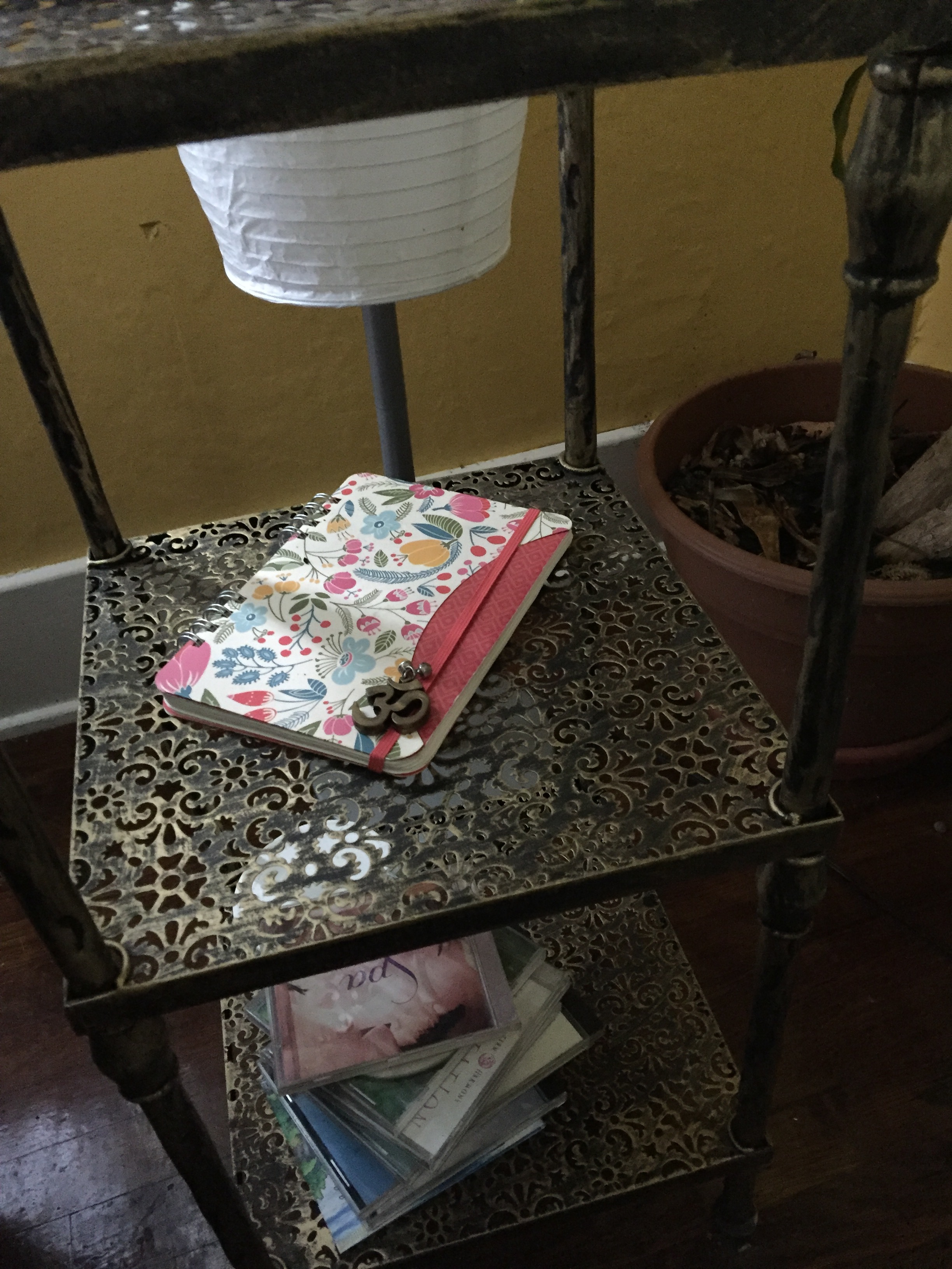 Closeup of a cool vintage corner table by the front windows of the living room.