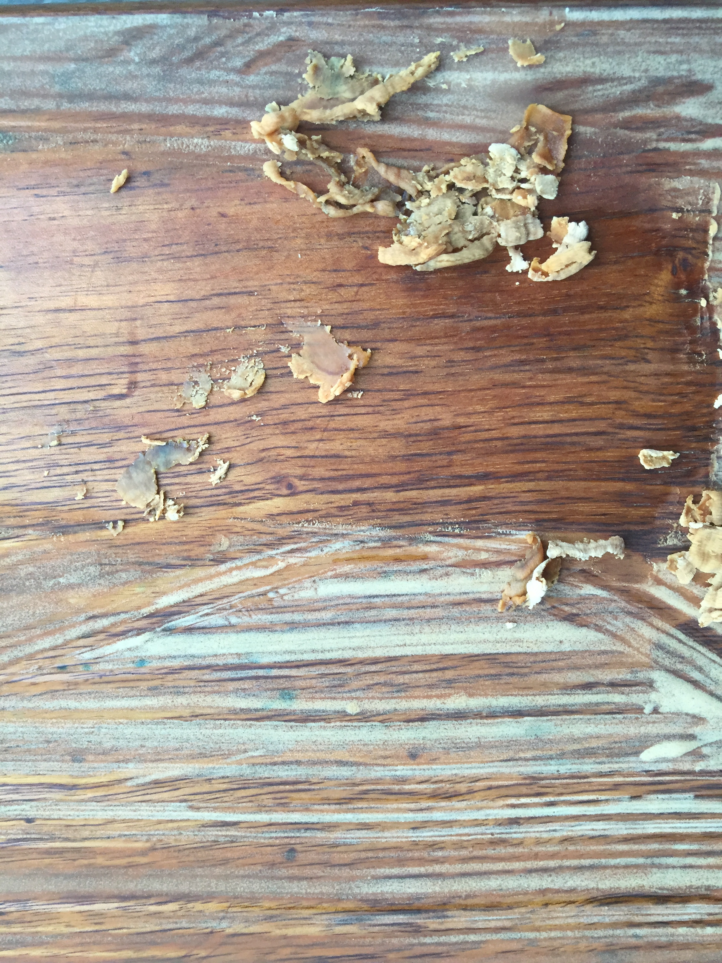 I scraped a little part of it here, and I can see the stripper did its magic all the way down to the wood.
