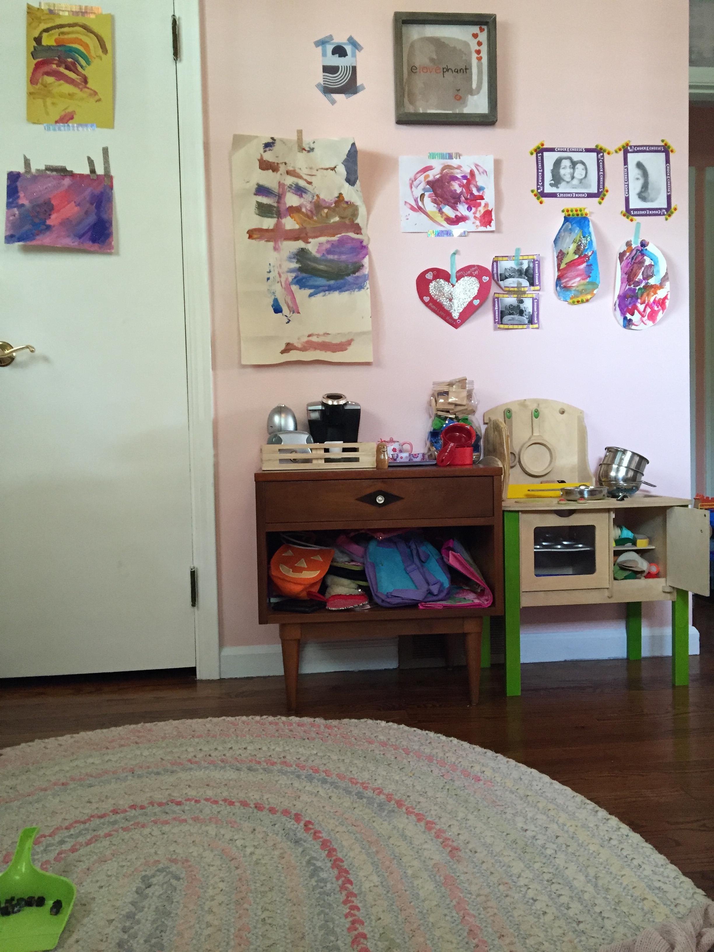 Just past the closet is Meena and Giuseppe's kitchen area (they both share these toys, but they just live in Meena's room). The nightstand serves as counter space and purse/backpack storage. I love using little nightstands in the kids' rooms. They are the perfect height for them for lots of different stuff. And then one day when she outgrows this as part of the play kitchen, she has a cool nightstand to use as an actual nightstand.