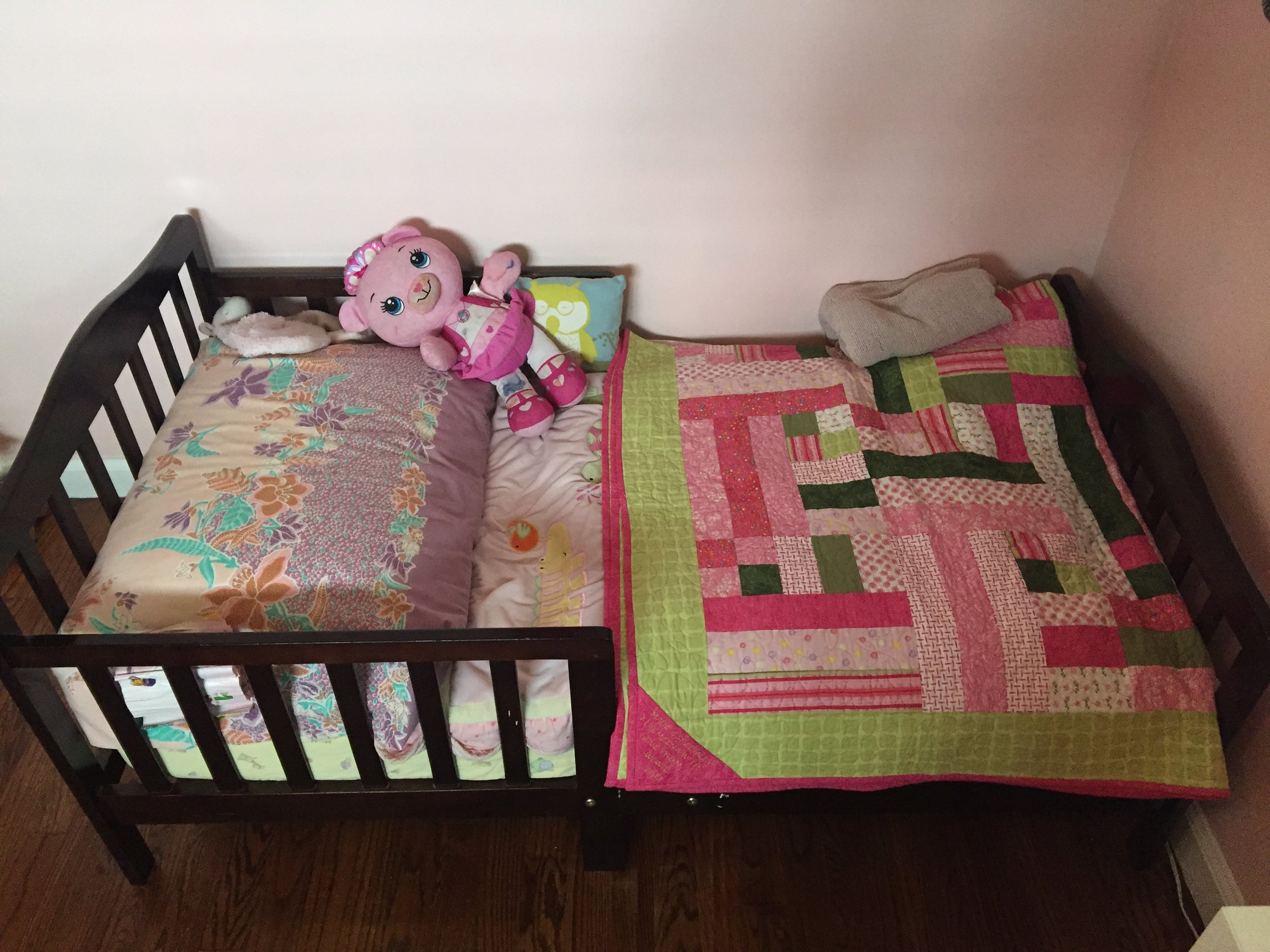 The toddler bed is just the perfect size for Meena, easy to get in and out of. Meena likes to sleep facing the mermaid because she doesn't want to look at the closet. Bed: Craigslist; Quilt: made by my MIL for Meena.
