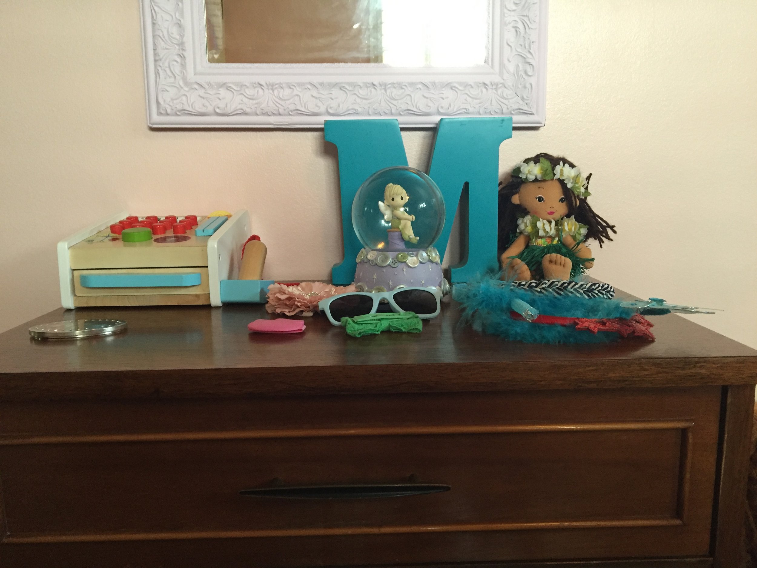 Below the mirror is a two-drawer nightstand. This is the PERFECT size "dresser" for Meena. Nightstands actually make amazing toddler "dressers" because they hold stuff, and they're the perfect height for a child. Meena can get her socks and such for herself and it is too small to topple over on her.