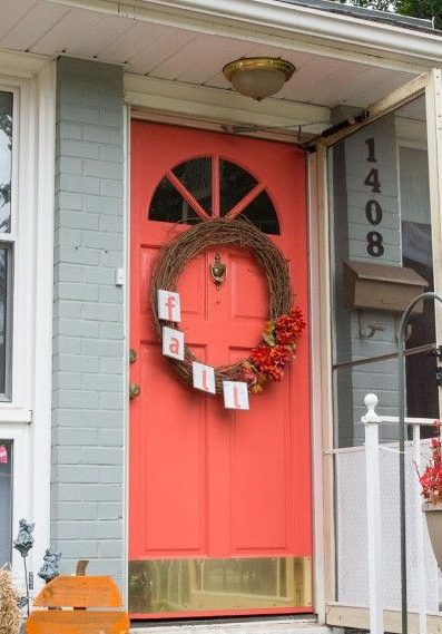 Image Credit: InvolvingColor.com This one is probably the most "real house" of the ones I put in here. This is exactly the same door we have (now I want a BIG brass kickplate like this!), and the surrounding exterior wall is gray like ours. Same style of numbers and mailbox too. And, this shade of coral looks like a winner to me!