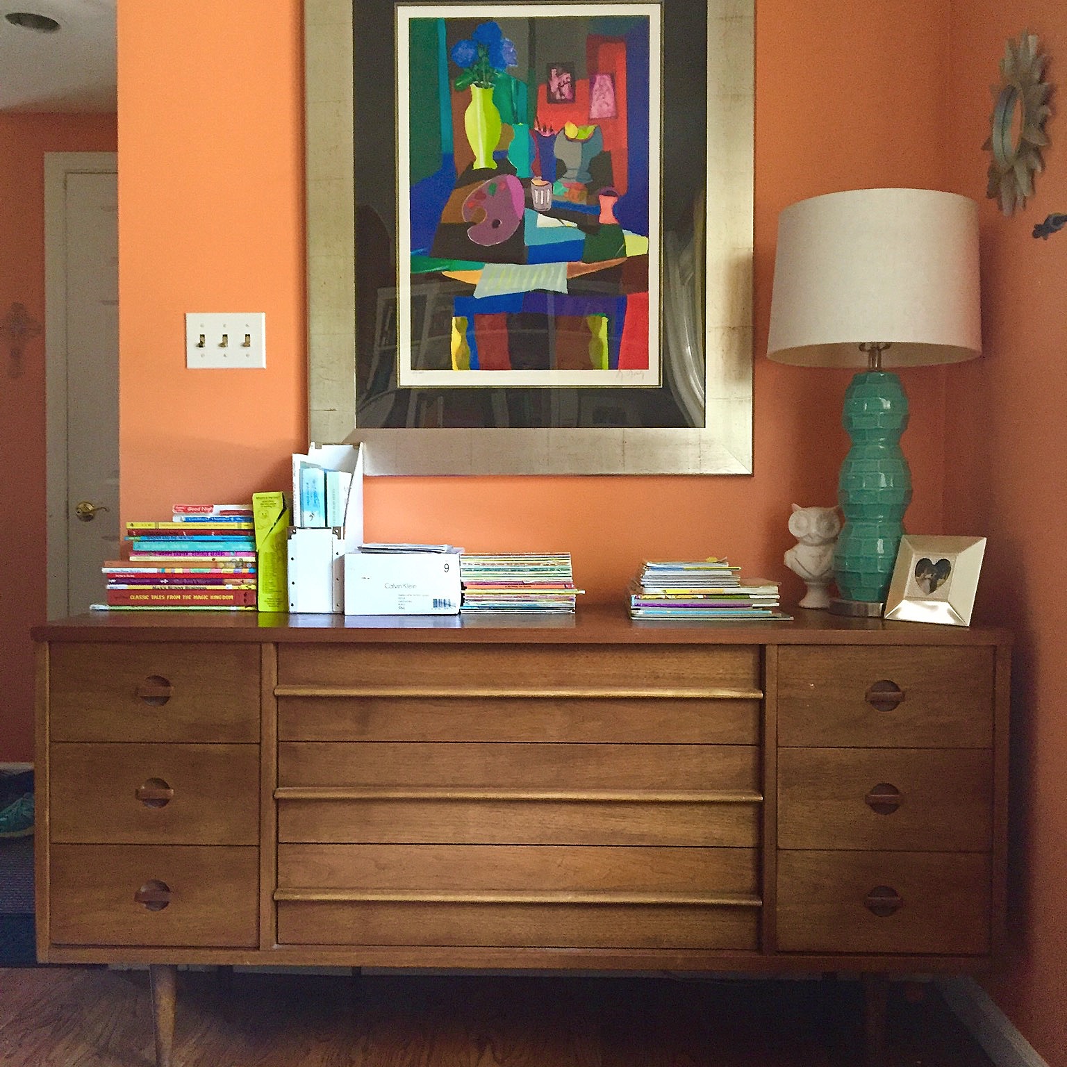 This is one of the credenzas (was once a long dresser, but now I call it a credenza cuz I'm fancy like that) in our living room. It stores winter clothes inside, and the top holds a bunch of our kids' books so they can easily find and reach them. LOVE the drawer pulls on this one!