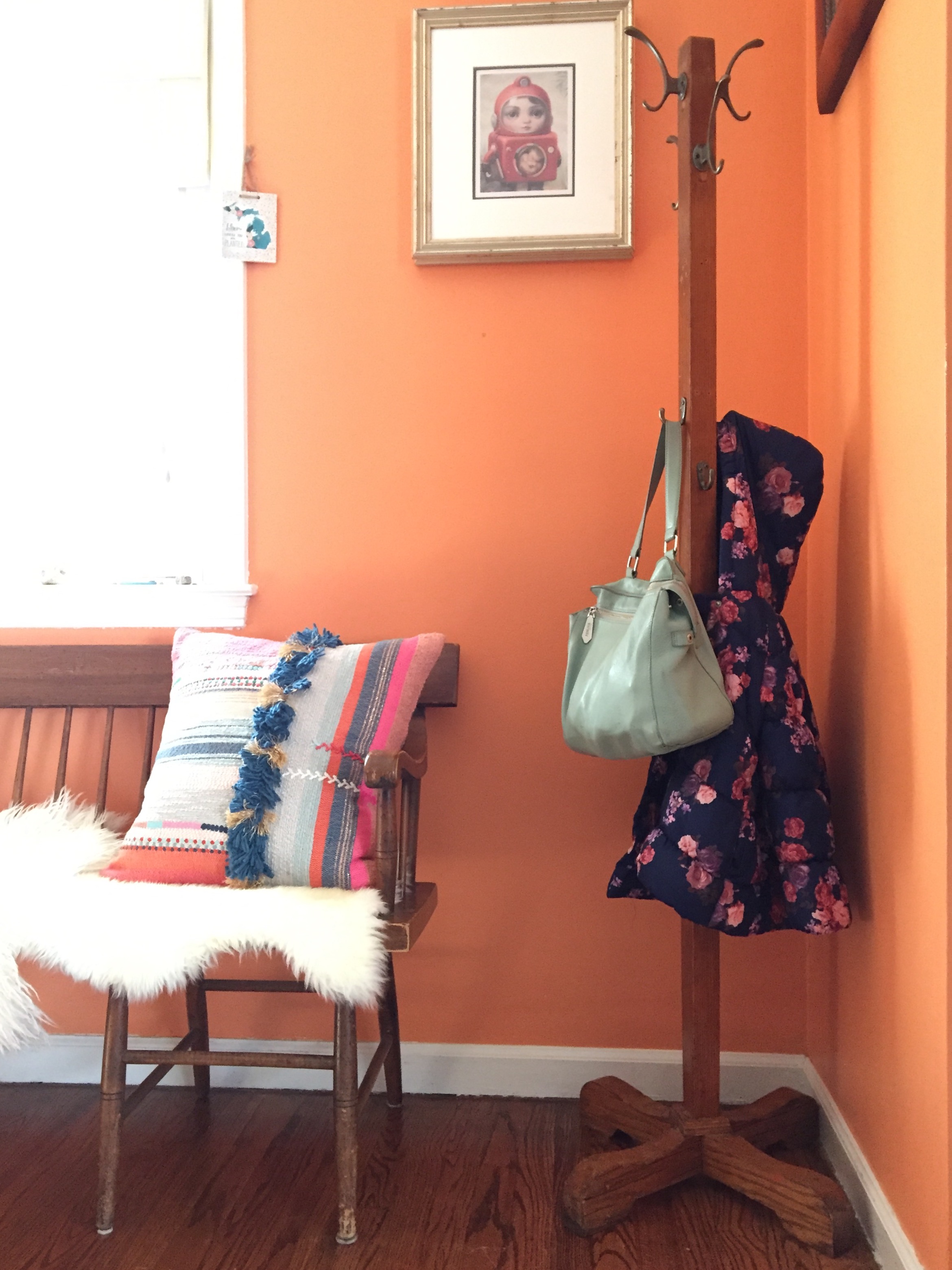 And here's a close-up of the coat rack side where the only thing on it is a purse and a cute little flower coat that take up very little visual space and happen to match perfectly with everything else in this space (more reality).
