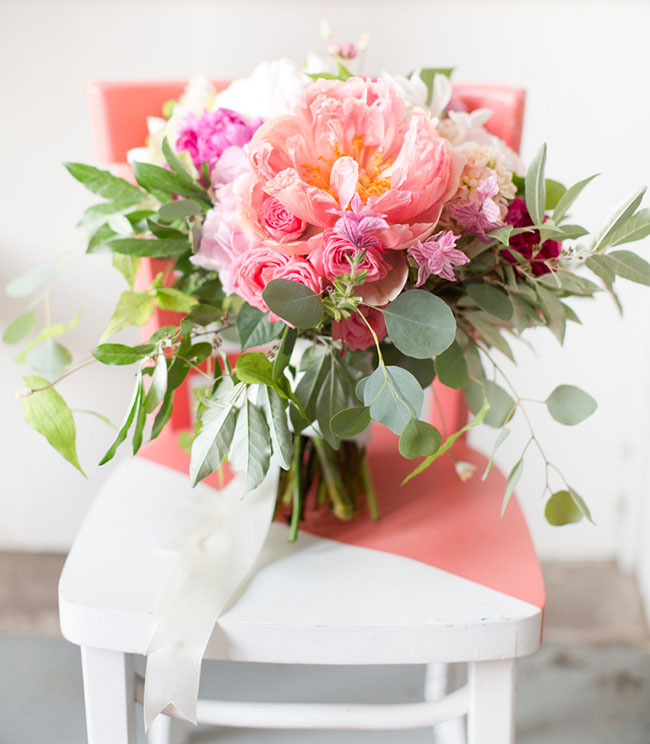 Amanda Veronee (Eclectic Warehouse Wedding) This gorgeous bouquet is a “boho-chic” fashionista’s dream-come-true! The vibrant, yet chic, color palette is only made more impactful by the greenery. This arrangement of hot-pink peonies, hydrangeas, roses, and a dash of eucalyptus—formed into a loosely-structured bouquet—is sure to provide just the POP of color and texture that you’ve been looking for! (Photo by Amy + Jordan Demos)