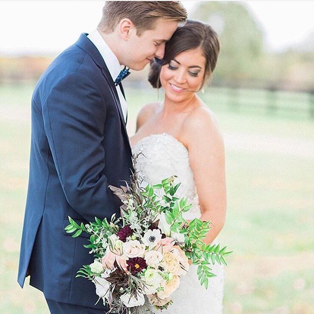 Kat Schmoyer, of Dear Sweetheart Events , is a true, fellow creative heart. So, when I first laid eyes on this winsome and romantic bouquet, I really wasn’t surprised that it was a product of her incredible talent! Featuring blush roses, ranunculus, burgundy accents, and a plethora of greenery, the arrangement is tightly gathered, yet full. But, let’s not play coy…the real STARS of this bouquet are the white anemones! If you’re looking for a bouquet that is chic and elegant, but with an element of the “unexpected”, this stunner may really appeal to you! (Photo by Abby Grace Photography!)