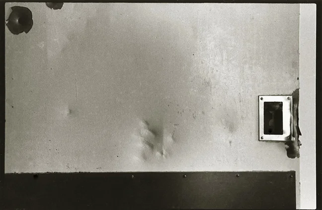 This image is of a door in a bedroom in the women's ward. The indentations you see in the metal were made by a fist.