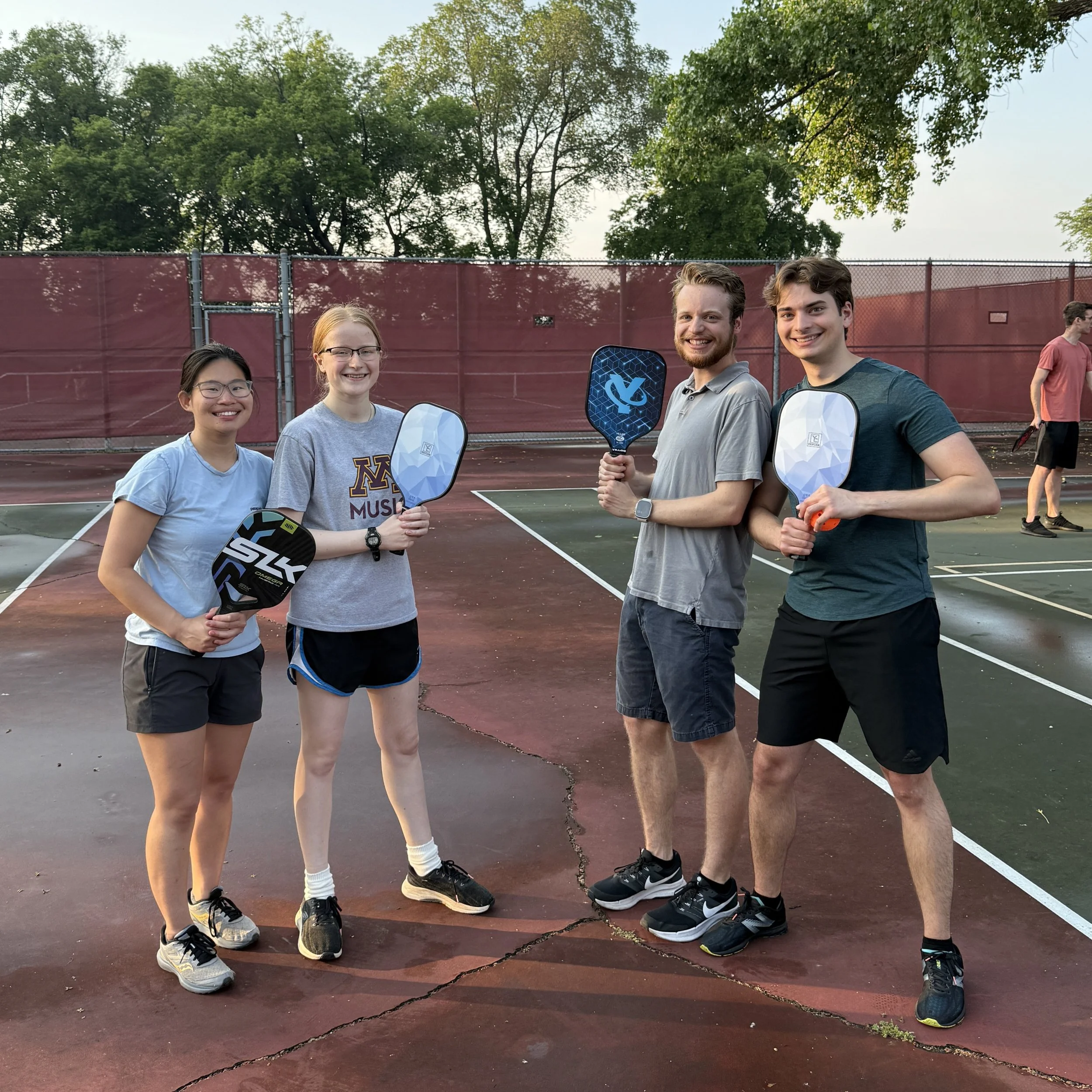 Group of students pose with pickleball rackets