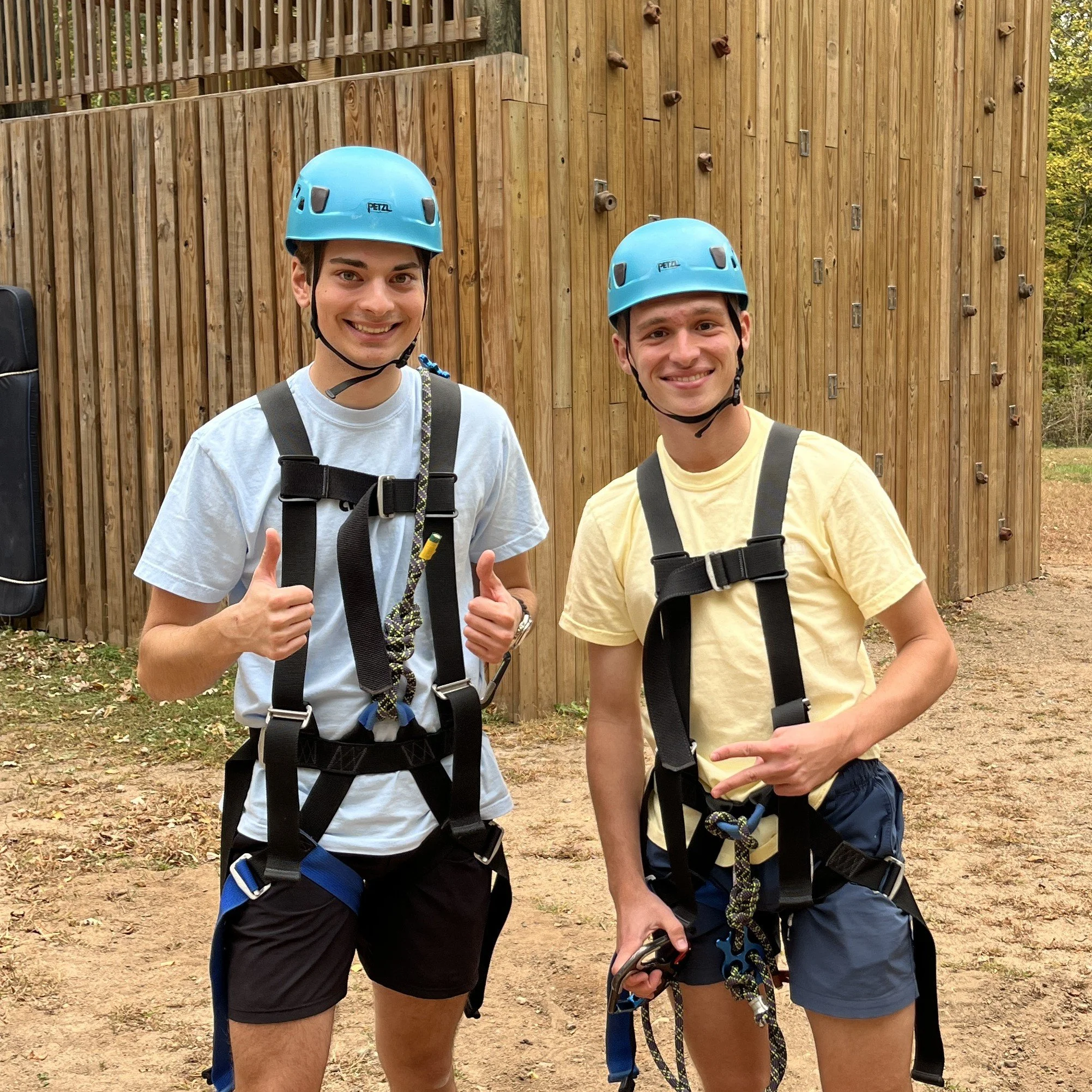 Two students in rock climbing gear at Fall Retreat