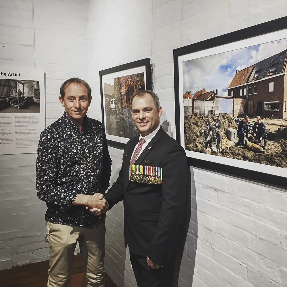 Artist Ian Alderman (left) and Jason Scanes - the Queensland government’s Anzac100 representative - are pictured at the exhibition opening event