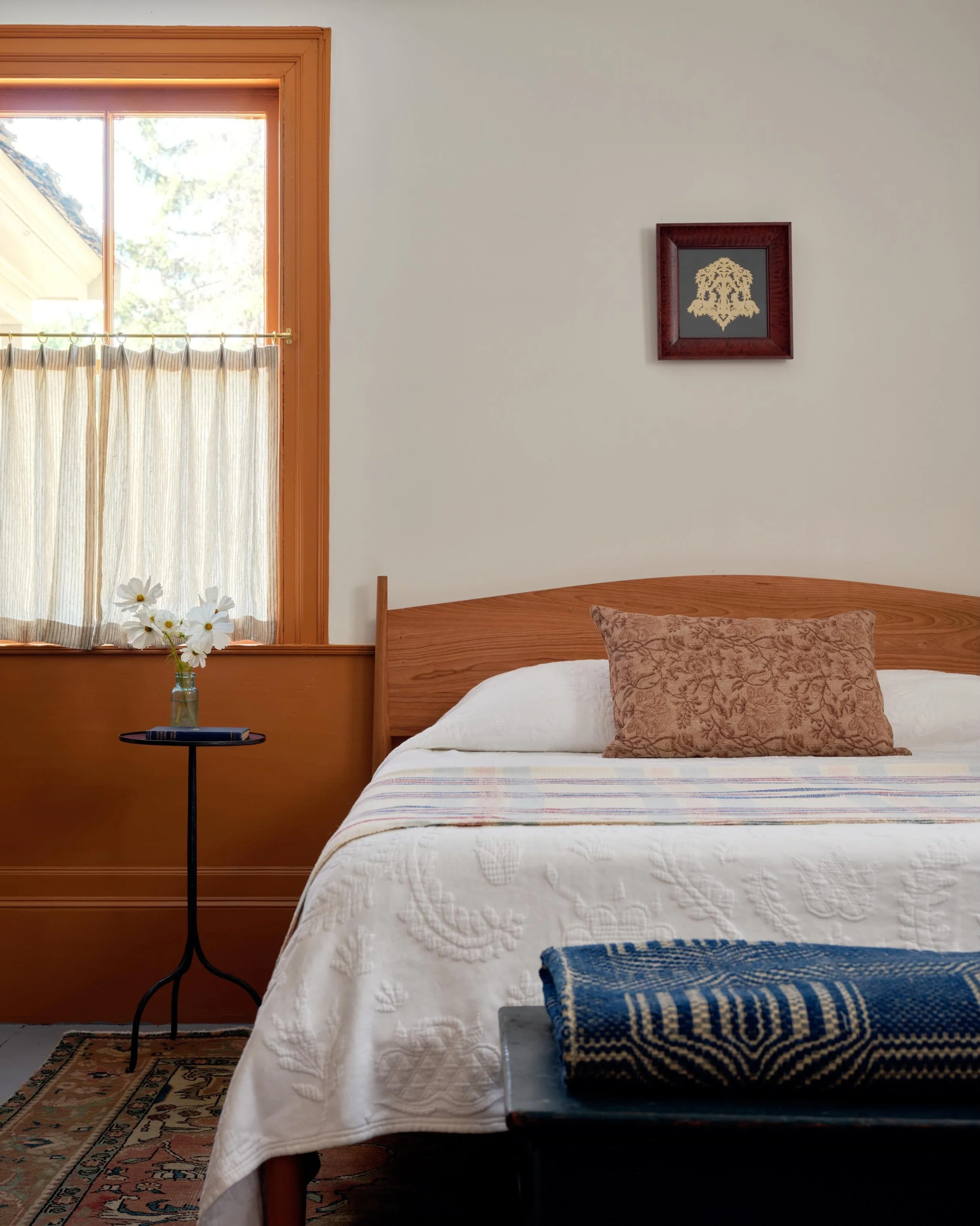 The front bedroom at the Kimball-Chandler house sits in the original parlor. While the rest of the house has the simple lines typical of early nineteenth-century Maine frontier homes, this room was always a bit dressier&mdash;with Federal-era molding