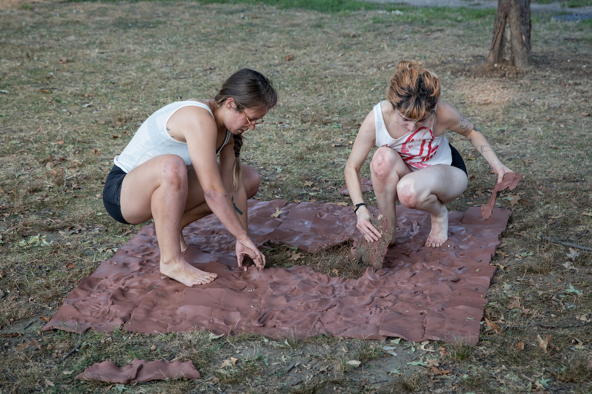 We tore up the pieces, trapping ourselves in a circle of clay. The pieces collected dirt, grass, acorns, and sticks. 