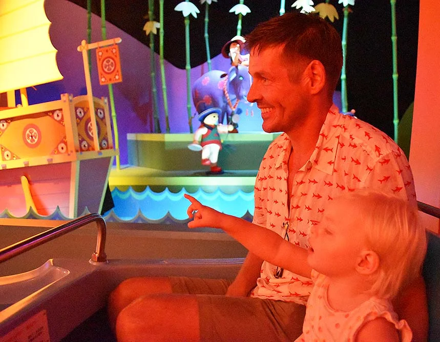 Rosie and Justin both in awe of the magic of the "It's a small world" ride at Disneyland.