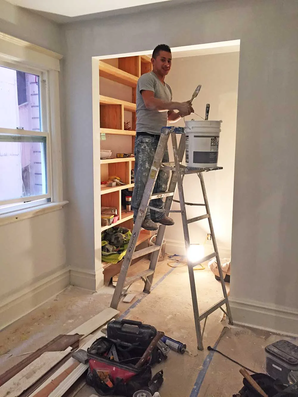 Here you can see the door gone and the shelving being installed. 
