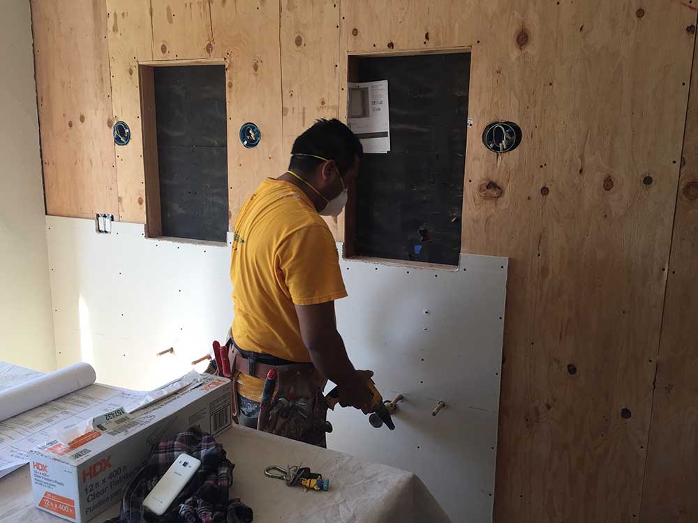 Preparing the cavities for the recessed medicine cabinets, and the electric for the mounted light fixtures. 