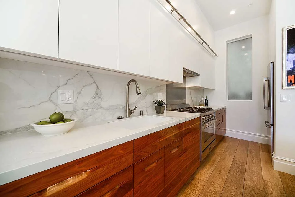 For easy maintenance, and a streamlined look, we had a single piece of stainless steel installed behind the range. 