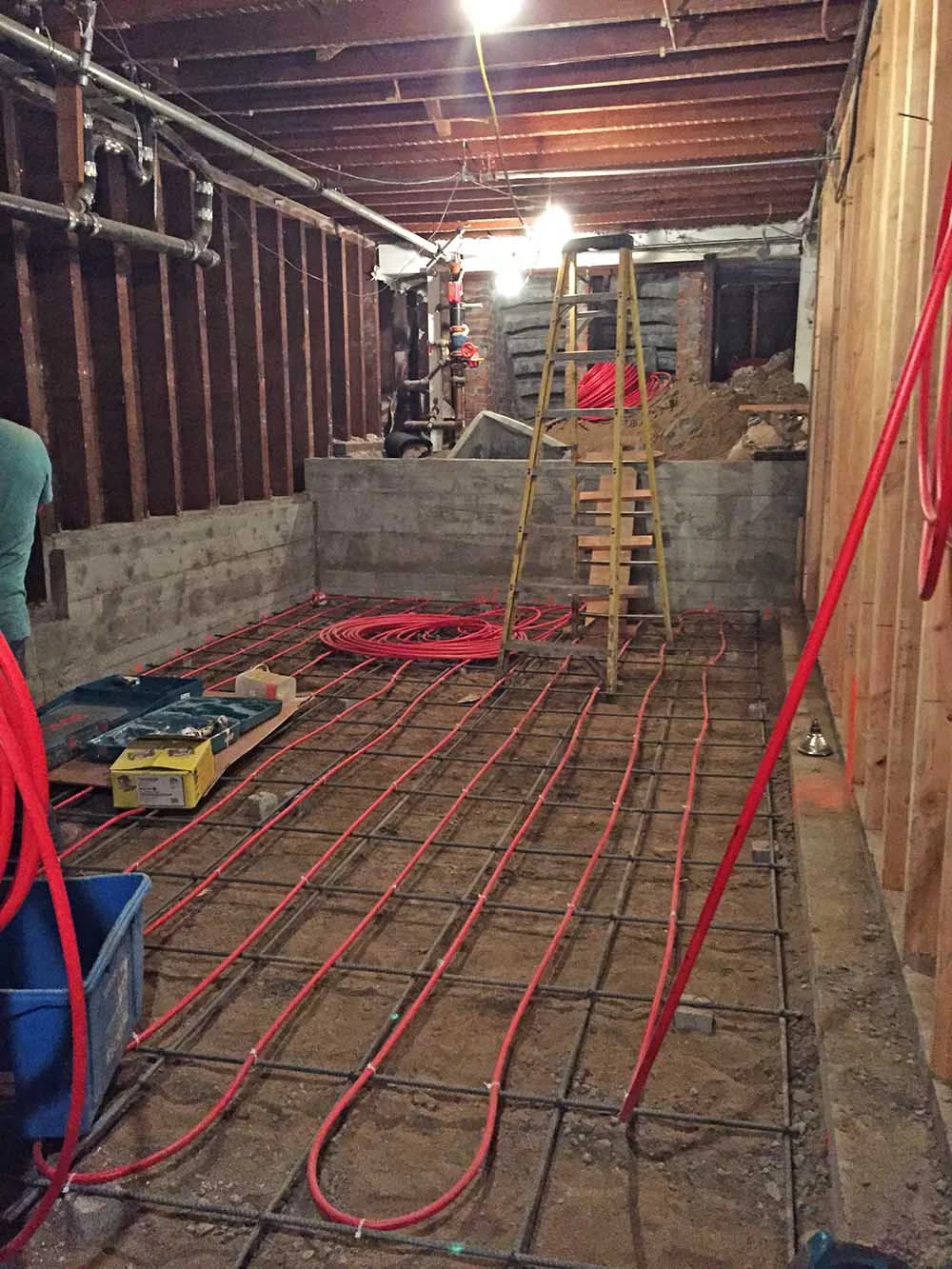 The underfloor heating is being installed, but there's not much natural light in here yet. 