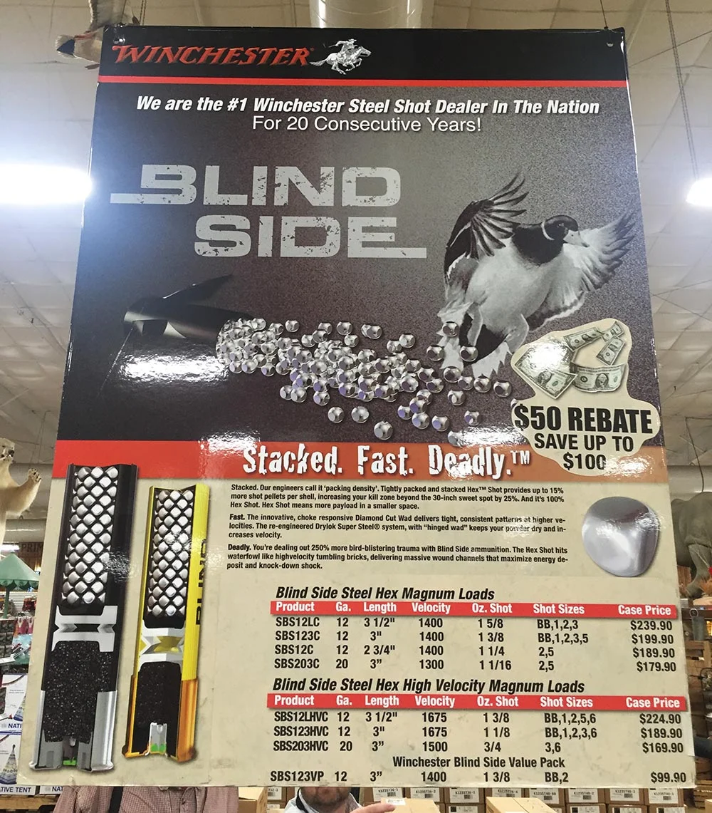 This is one of the promotional posters we saw. The third paragraph reads: "Deadly. You're dealing with 250% more bird-blistering trauma with Blind Side ammunition. The Hex Shot hits waterfowl like high velocity tumbling bricks, delivering massive wound channels that maximize energy deposit and knock-down shock". 