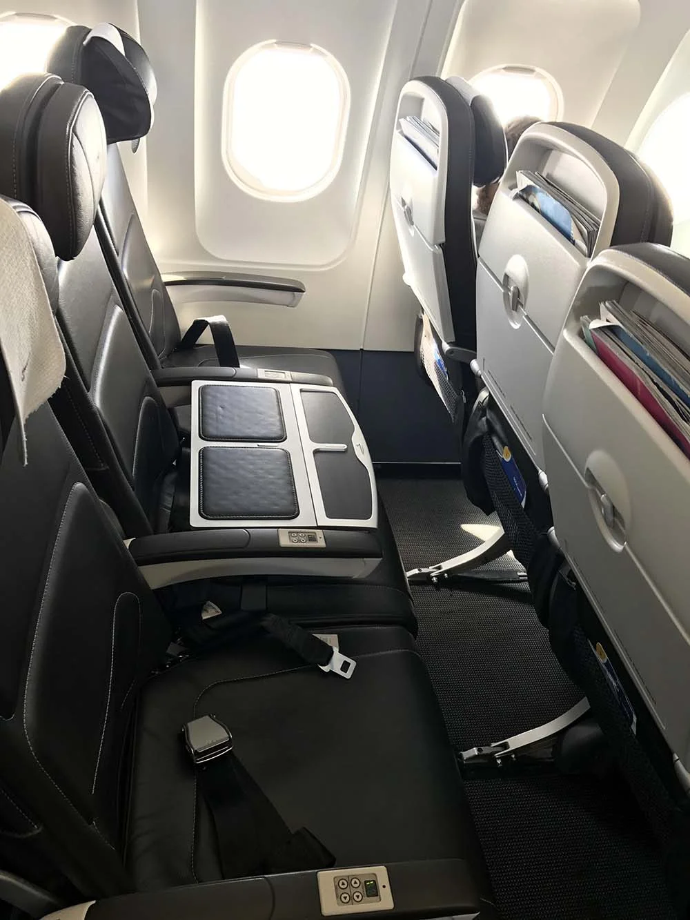 A row of three seats in Business class, with the middle seat being used to separate passengers. Only the two seats on either side of the "table seat" are available to