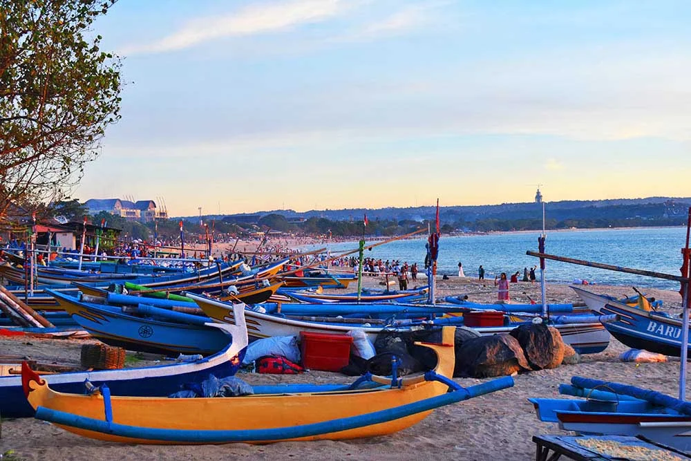 Traditional fishing boats lined up along Jimbaran Beach in front of the fish market. 