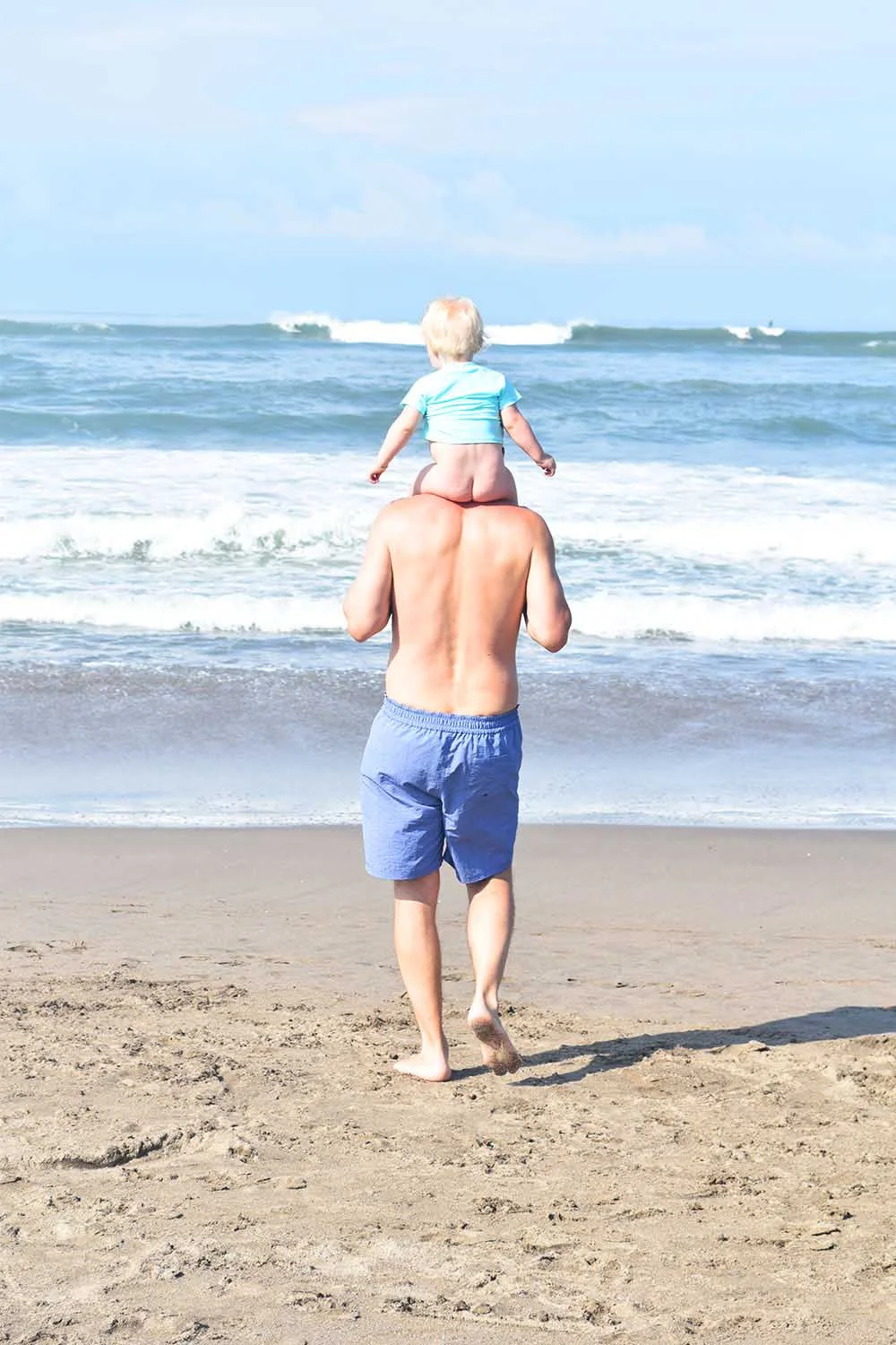 Rosie and Justin hitting the surf on Jimbaran Beach, where the sand and sea are always picture perfect.