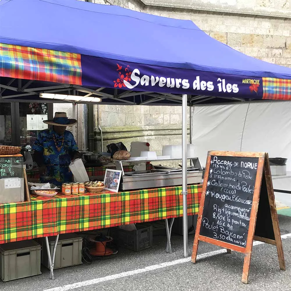 The market vendor selling the deliciois Martinique chicken stew!