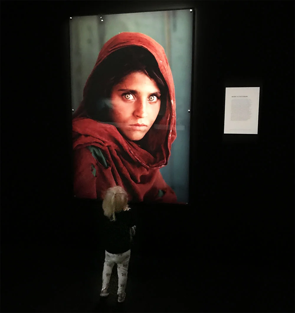Rosie admiring one of the world's most famous photographs, 'Afgan Girl' by Steve McCurry.