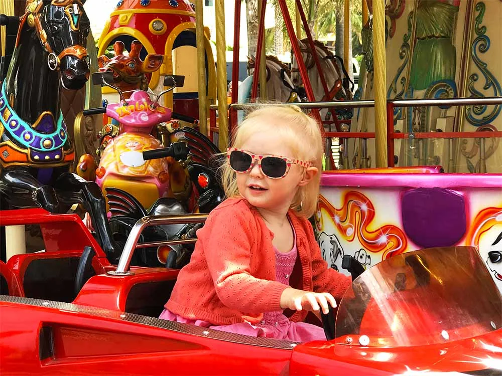 Rosie enjoying one of the carousels on La Croisette.
