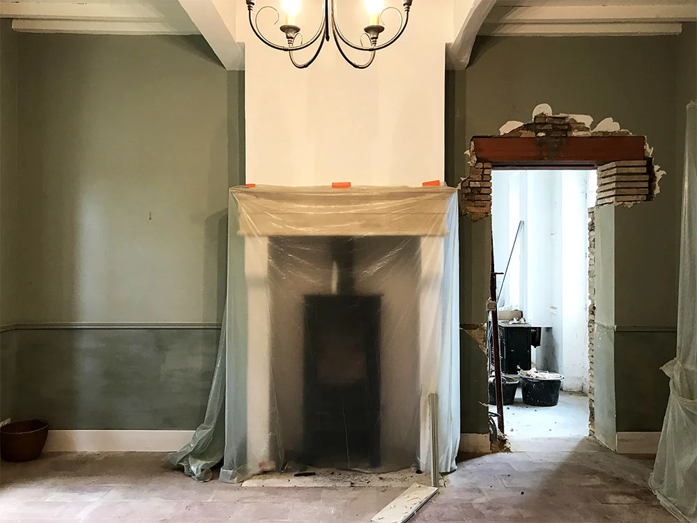 The previous owners were using this room as a library, but we will be using it as our family dining room. We're creating symmetrical glass doorways, on either side of the fireplace, that will open into the orangerie. It's going to be so much nicer to be able to access the orangerie from the main house. Another bonus is all the extra light it lets into this room. 