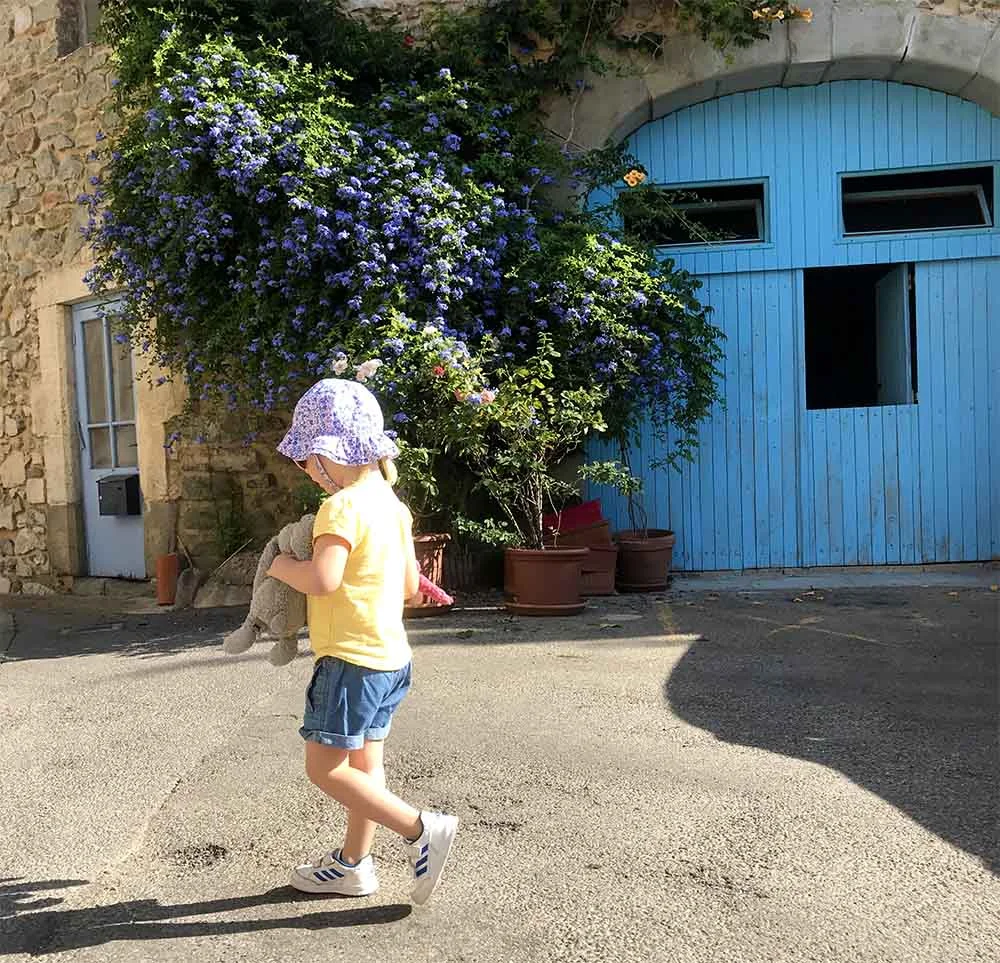 Rosie exploring the sweet village of Paraza. I love the bright colors you find in the South of France, on doors, windows, and in gardens. 