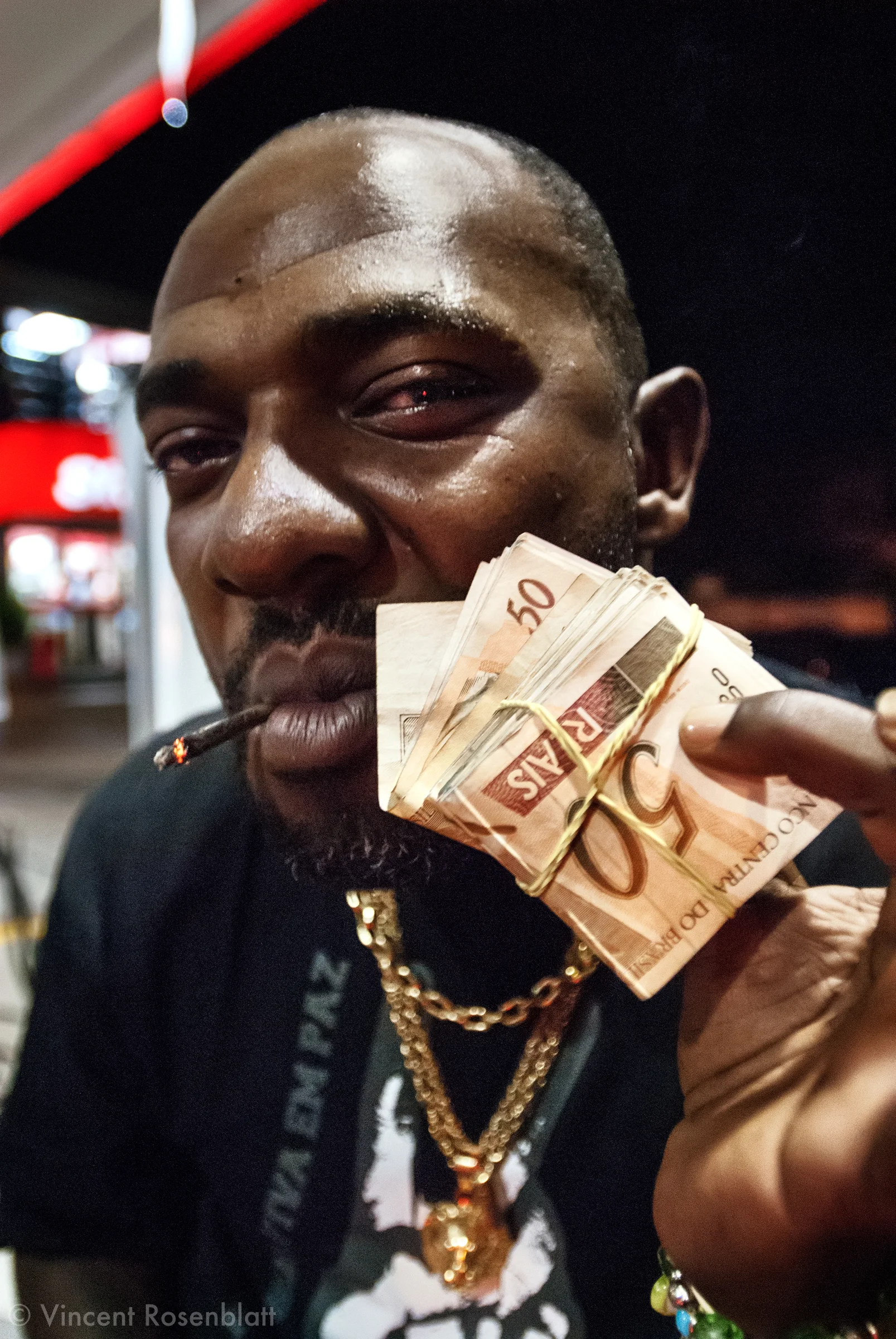 Mister Catra, godfather of funk carioca. During a break between two shows , Catra shows the takings of the night..