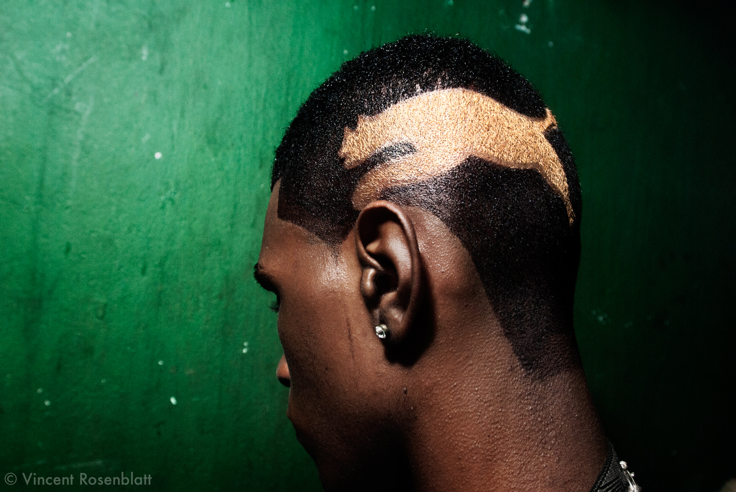  MC Ombrinho, a young funk singer from the favela Turano, had his hair cut and dyed with the Puma sneakers' logo. Baile atclub Boqueirão, Downtown Rio de Janeiro. The Funk carioca movement is fashion and look as well : the boys will use their shaved 
