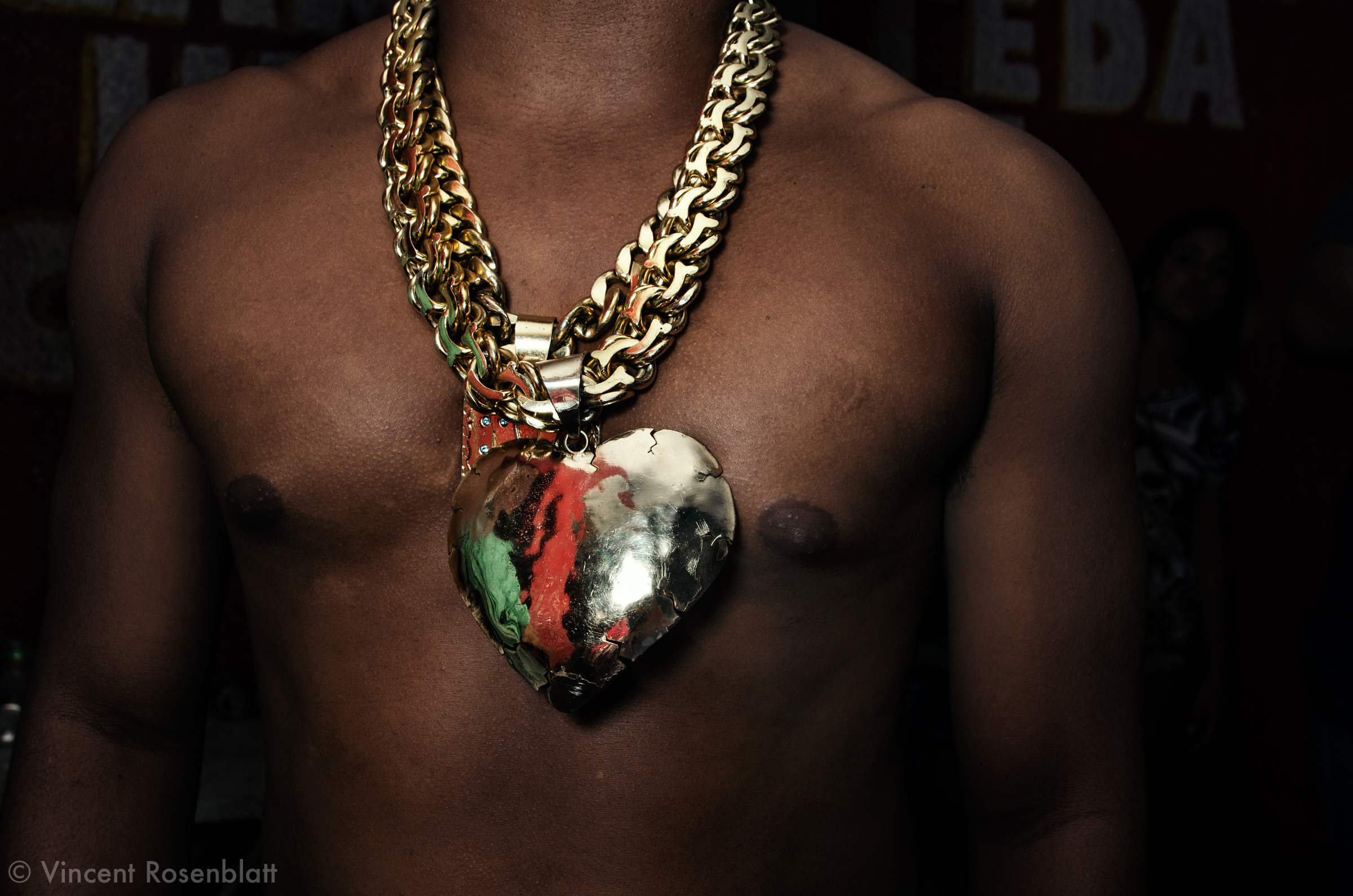  Giant heart pendant  Baile Funk in Morro do Andaraí. zona norte, Rio de Janeiro, 2011..The Funk carioca movement is fashion and look as well  : The boys show off their muscles and naked torsos, adorned with chains and tattoos, accessories which will