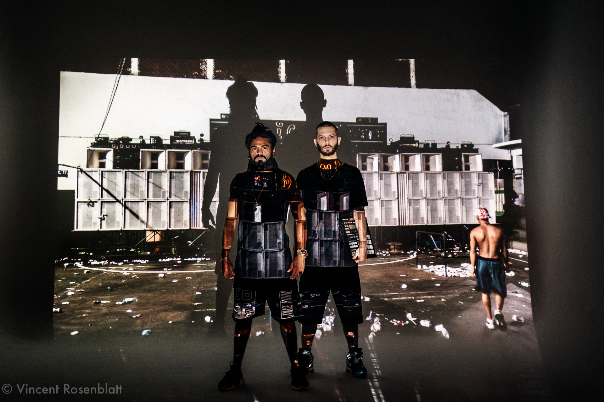  MC Tchelinho & DJ Leo Justi - Heavy Baile crew 2017 - photographed front of a slidesjow of Vincent Rosenblatt's Rio Baile Funk series 