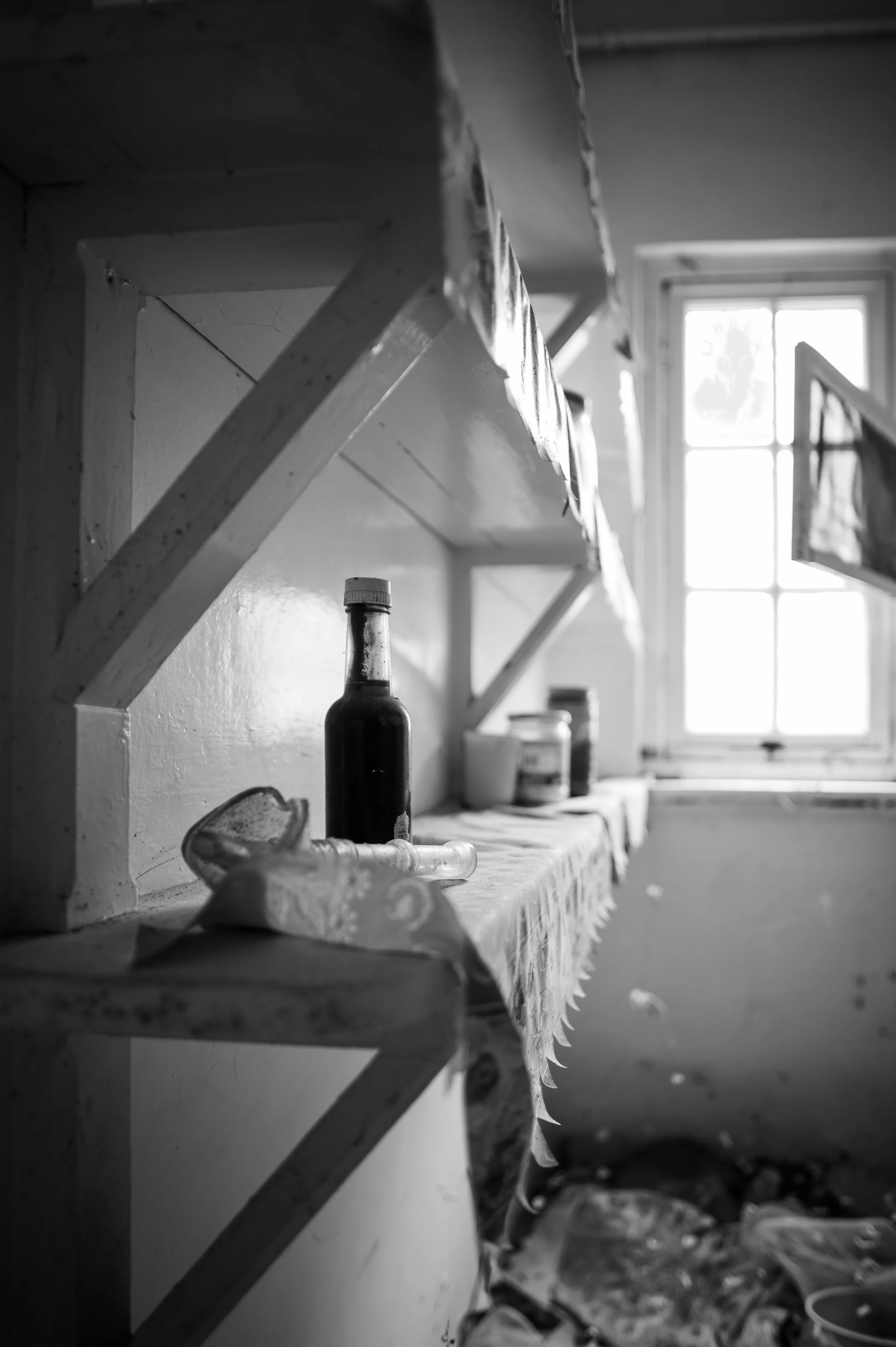 Still on the Shelf.

Bottles, small objects, and everyday things
still rest quietly on the shelf.

Dust has settled over them,
but nothing seems to have been moved.