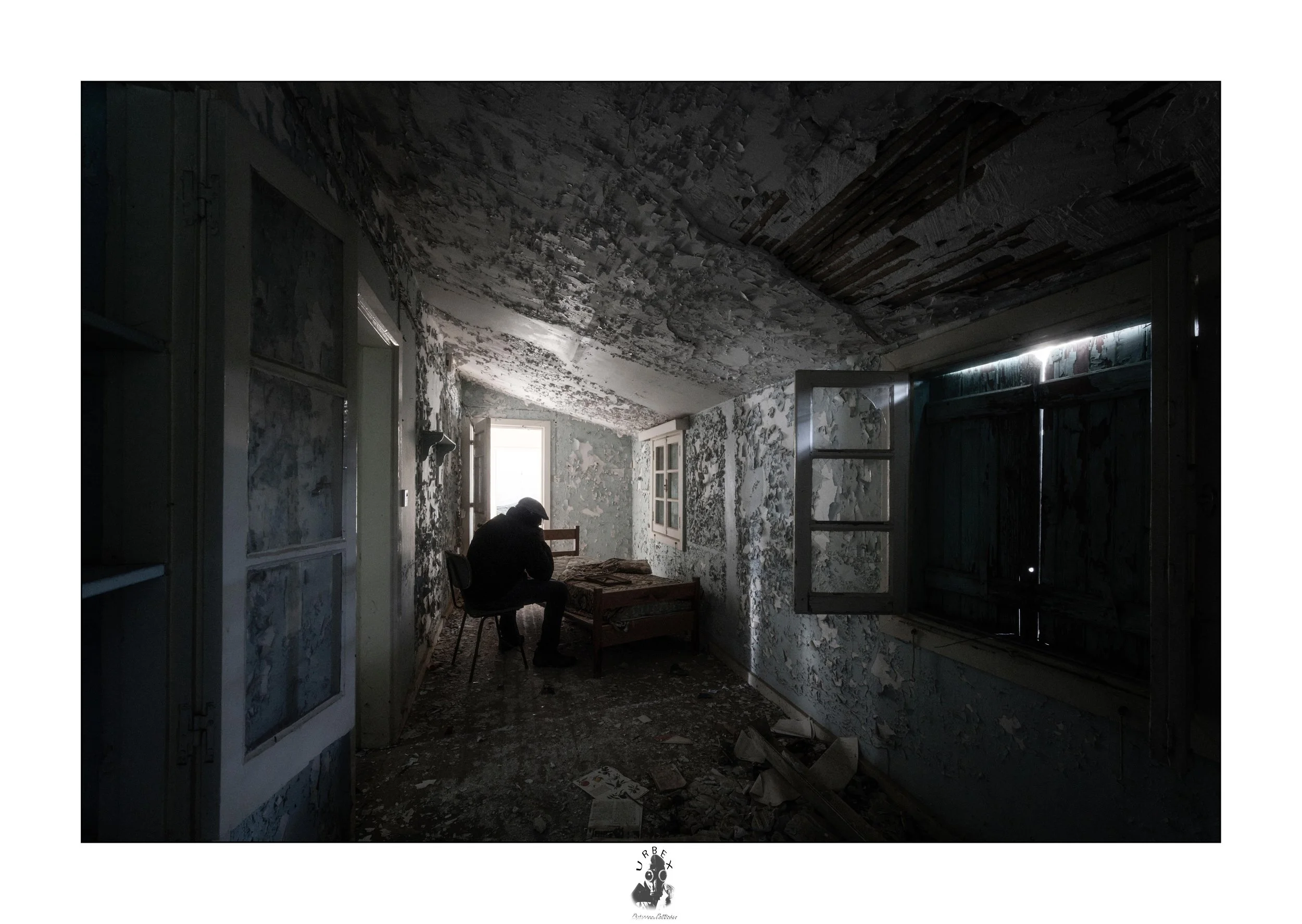 The Visitor.

An empty room, slowly fading with time.
Peeling walls, broken light, forgotten furniture.

For a moment, someone sits there in silence,
simply taking in what is left behind.