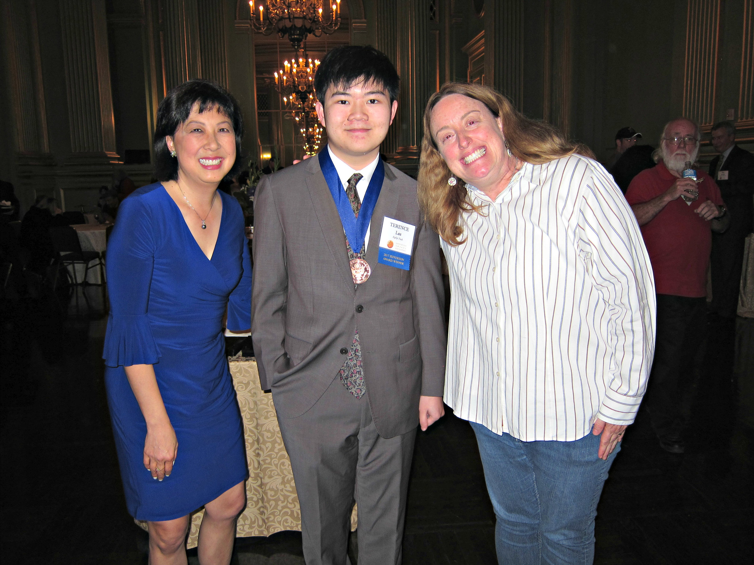 Terence Lee, center, wearing his Jefferson Award Medal, is flanked by CBS KPIX, Sharon Chin, left, and Jennifer Mistrot