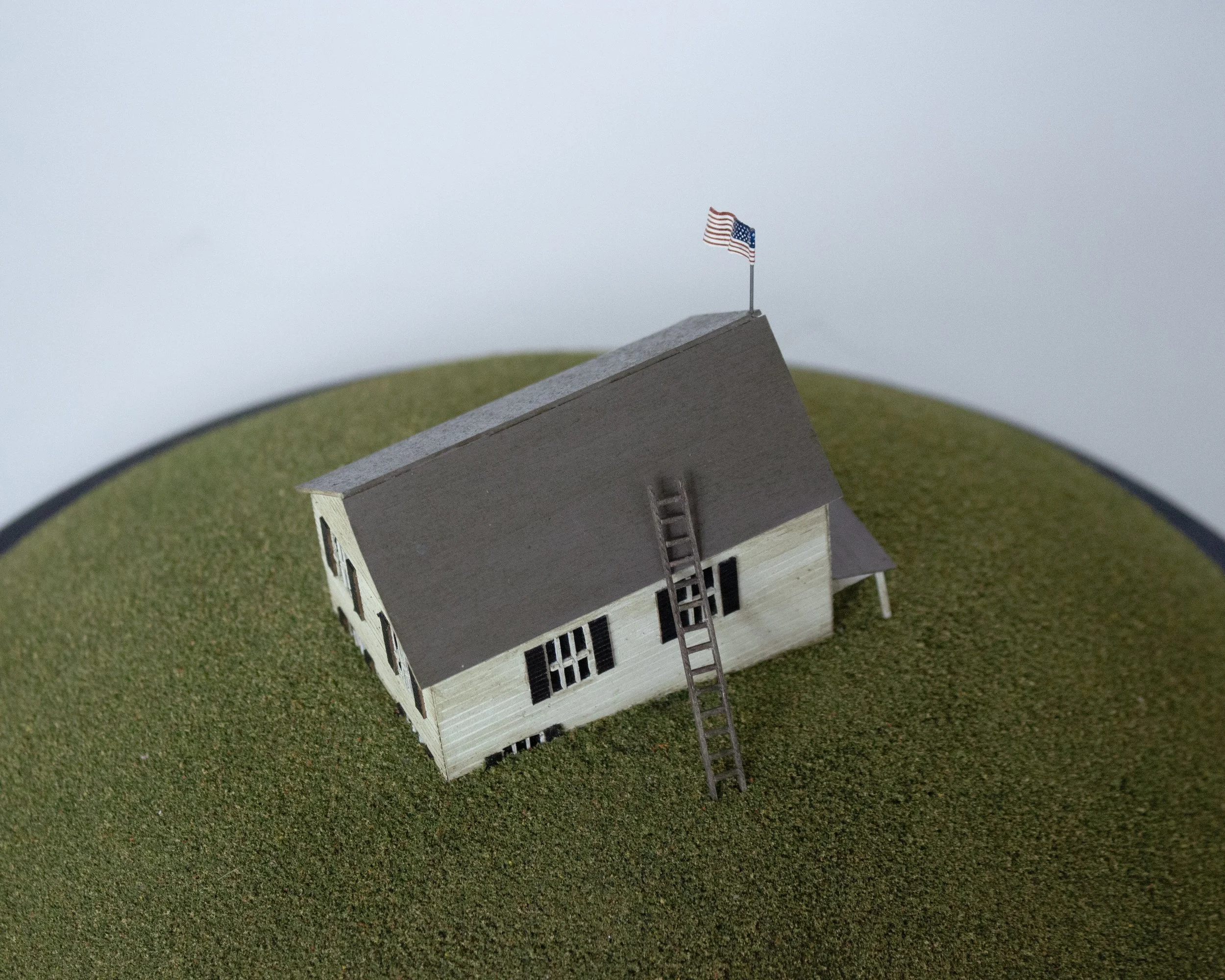 We Used to Live Here 2025 16 in x 13 in x 13 in Glass cloche, wood, foam, turf, wire, paper, acrylic, and enamel paint