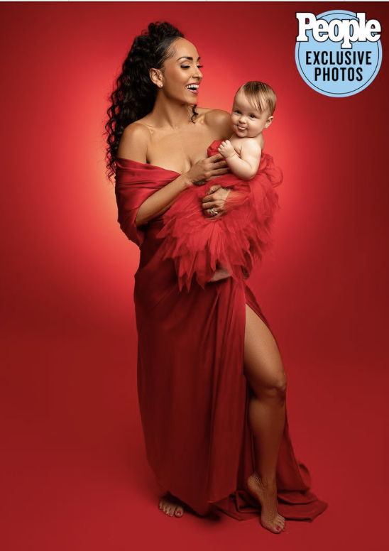Robin Arzón holds her baby daughter in a red couture gown during a luxury Mommy and Me portrait session photographed by a NYC maternity photographer, featured as a People Magazine exclusive